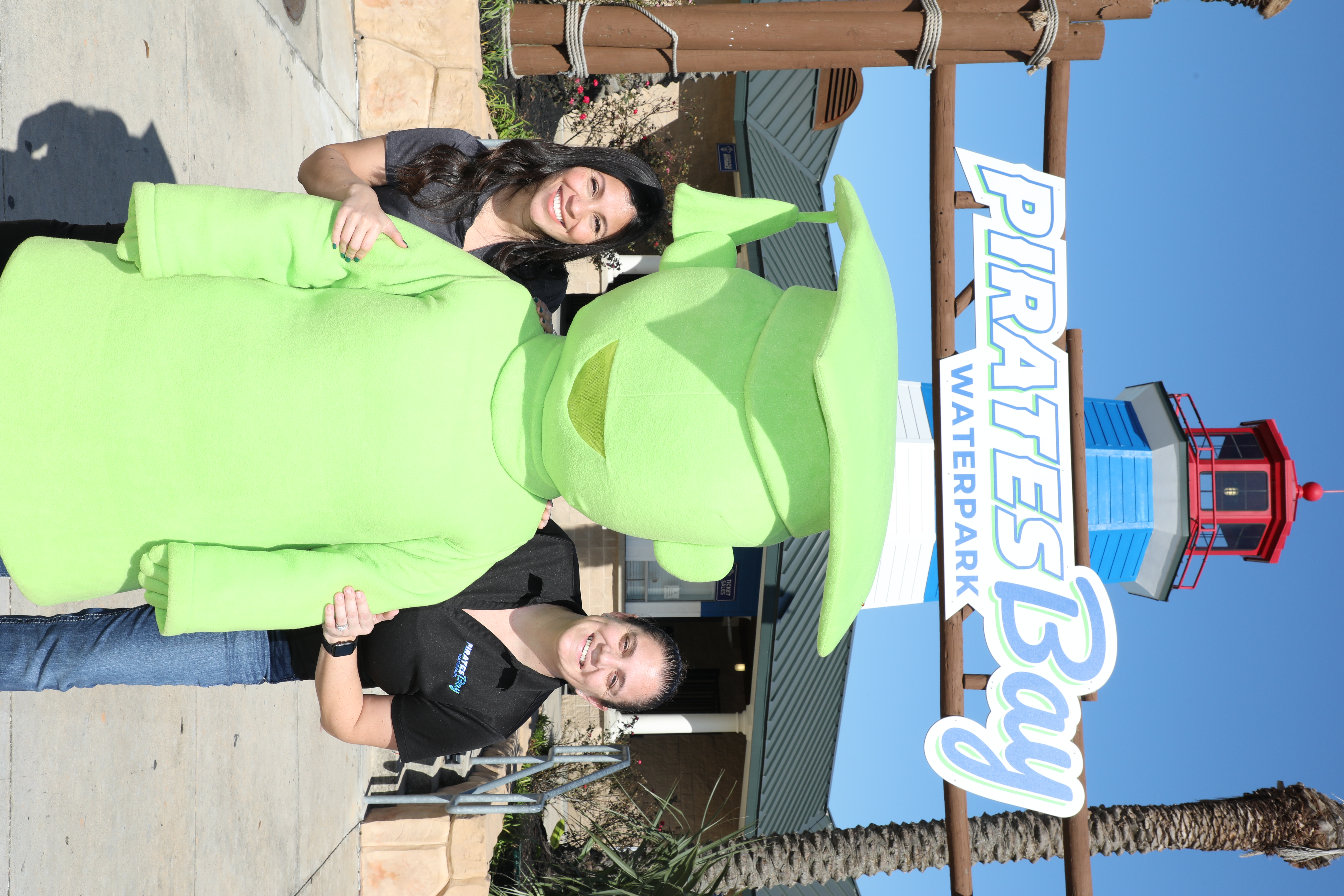 Erika Foster GCCISD edfo director and city of baytown stand next to giant mascot at pirates bay