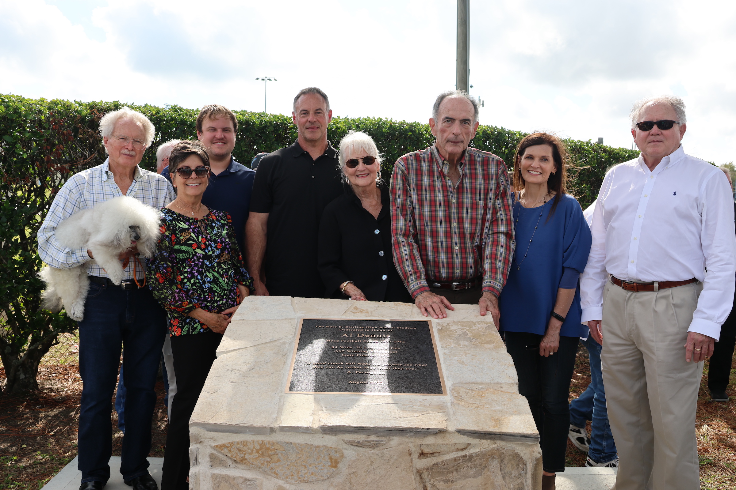 Al Dennis and his family pose with the plaque