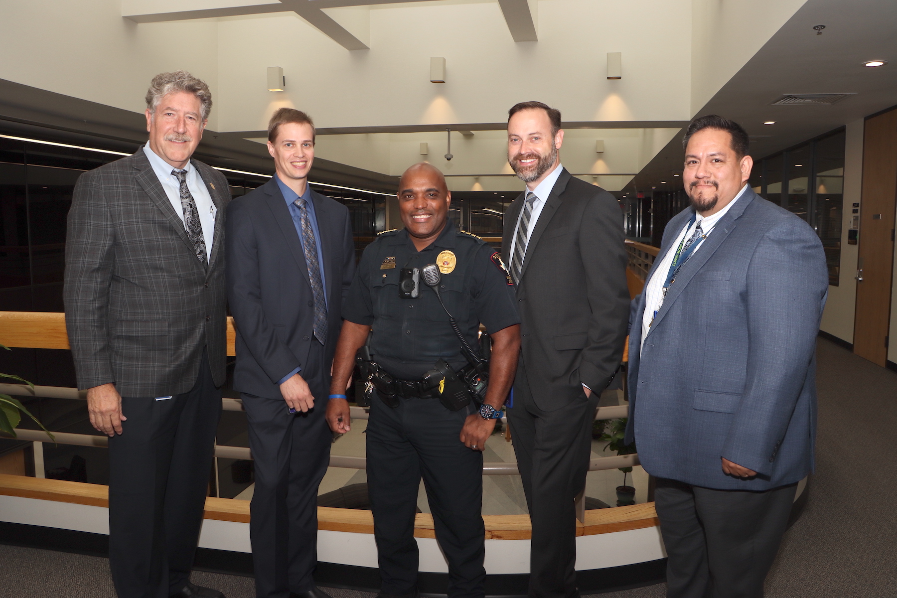 District leaders pose in the administration building lobby