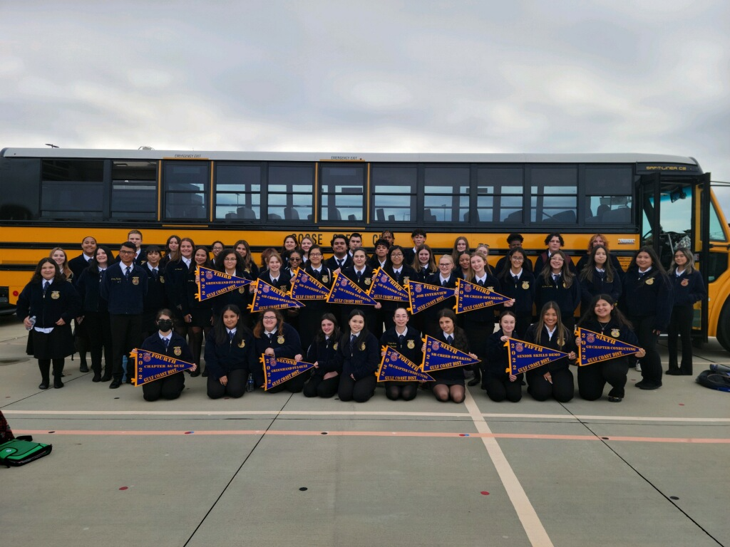 FFA Team pose together in front of school bus