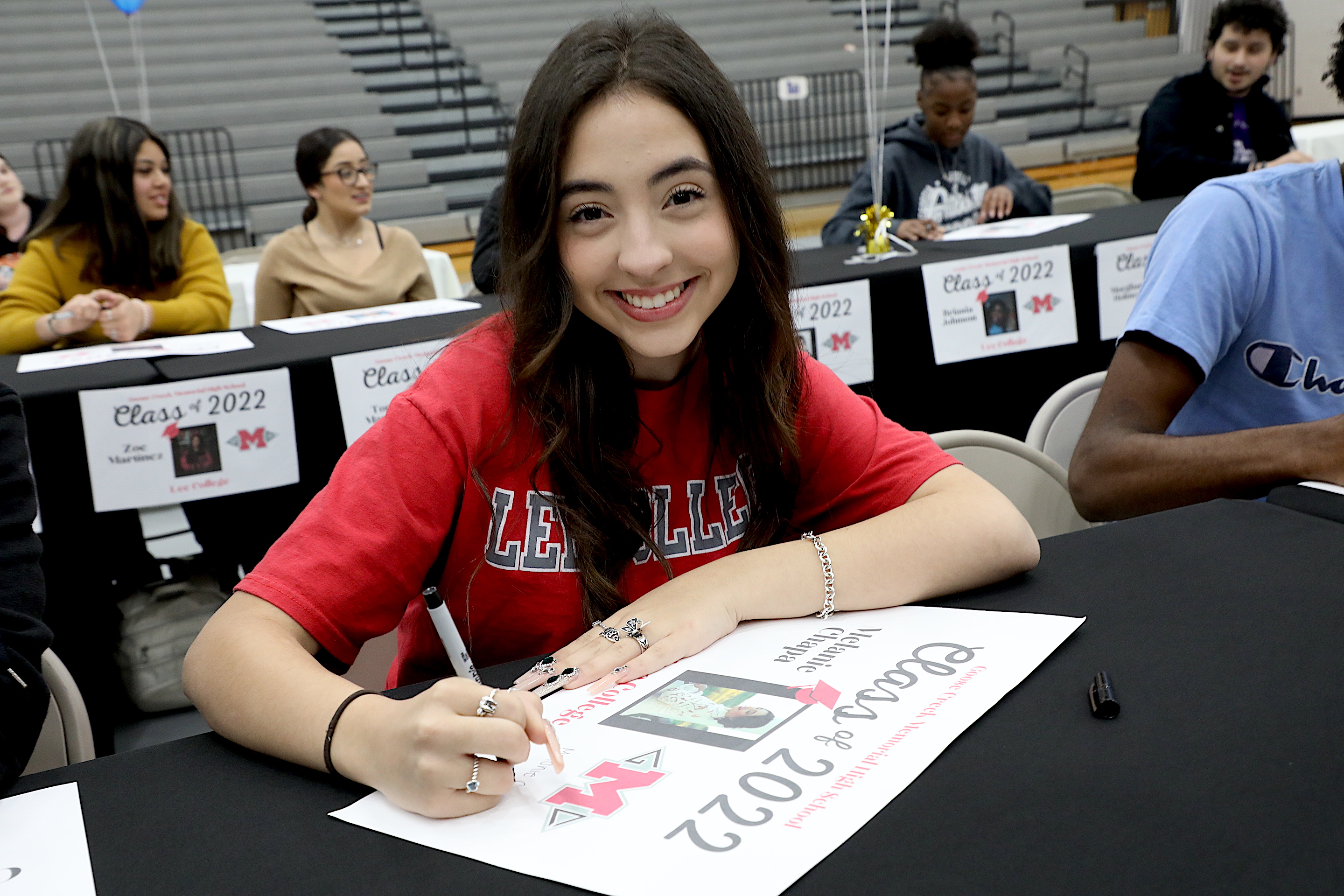 Melanie Chapa ceremonially signing for Lee College