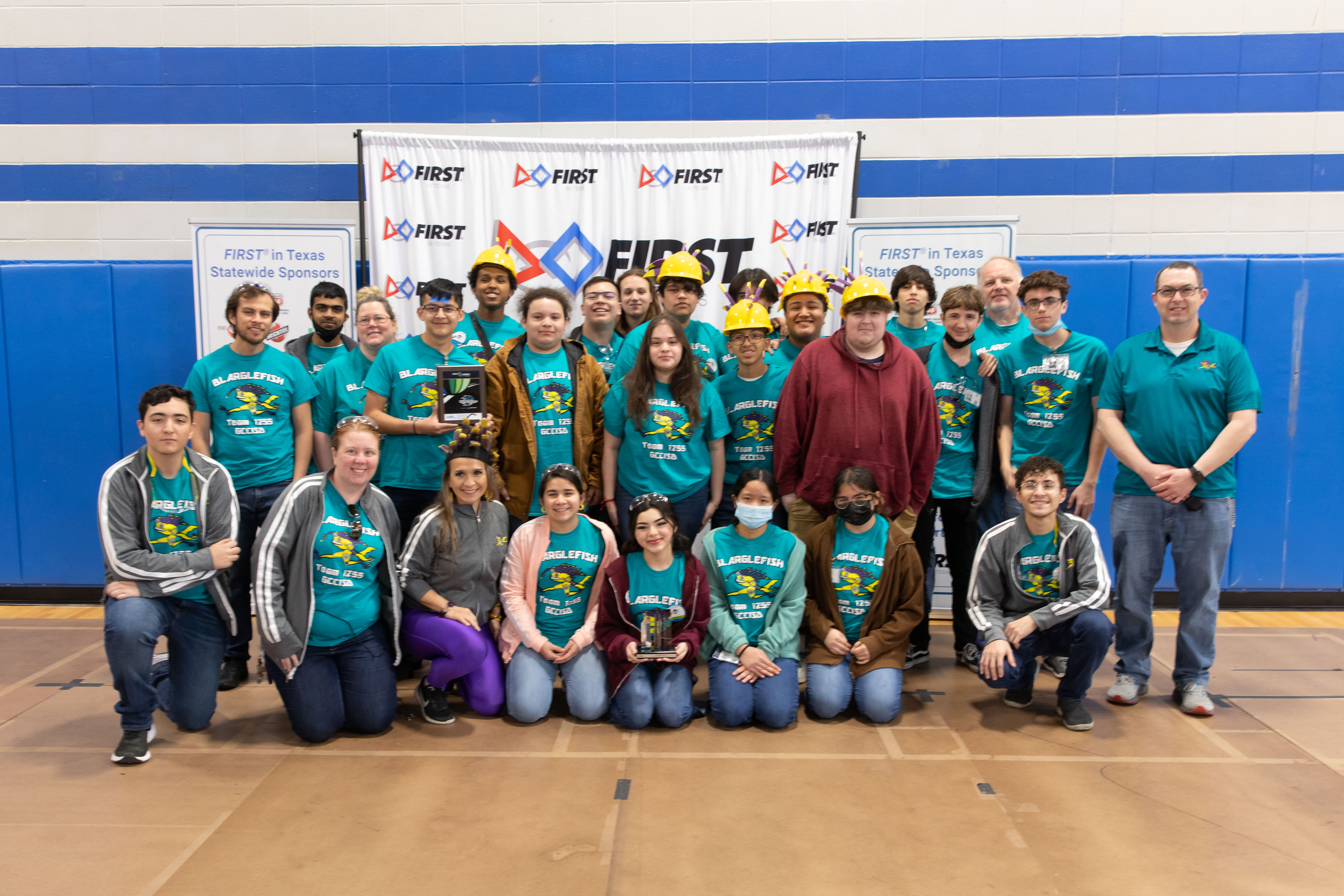 The blarglefish team stands together wearing their team shirts