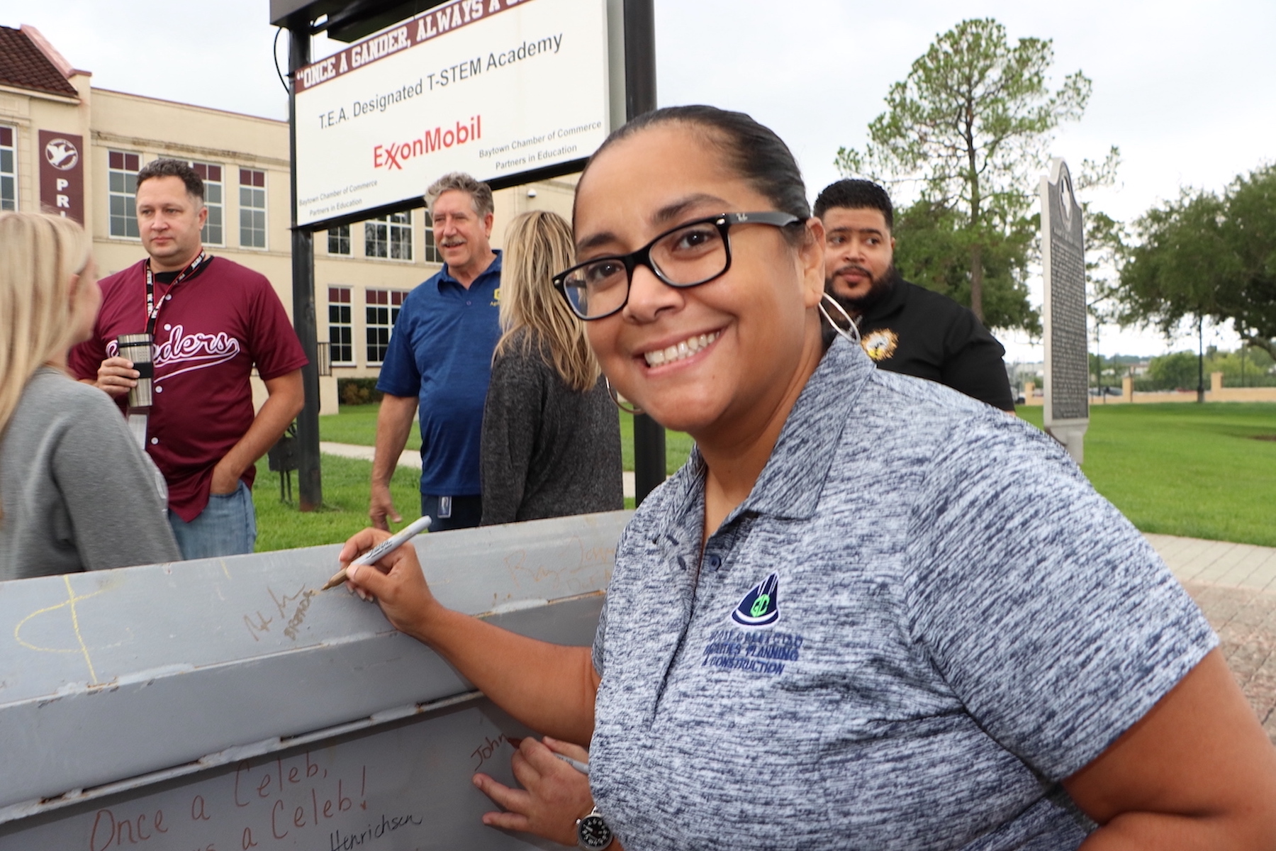 Brenda signs beam at new lee fine arts building