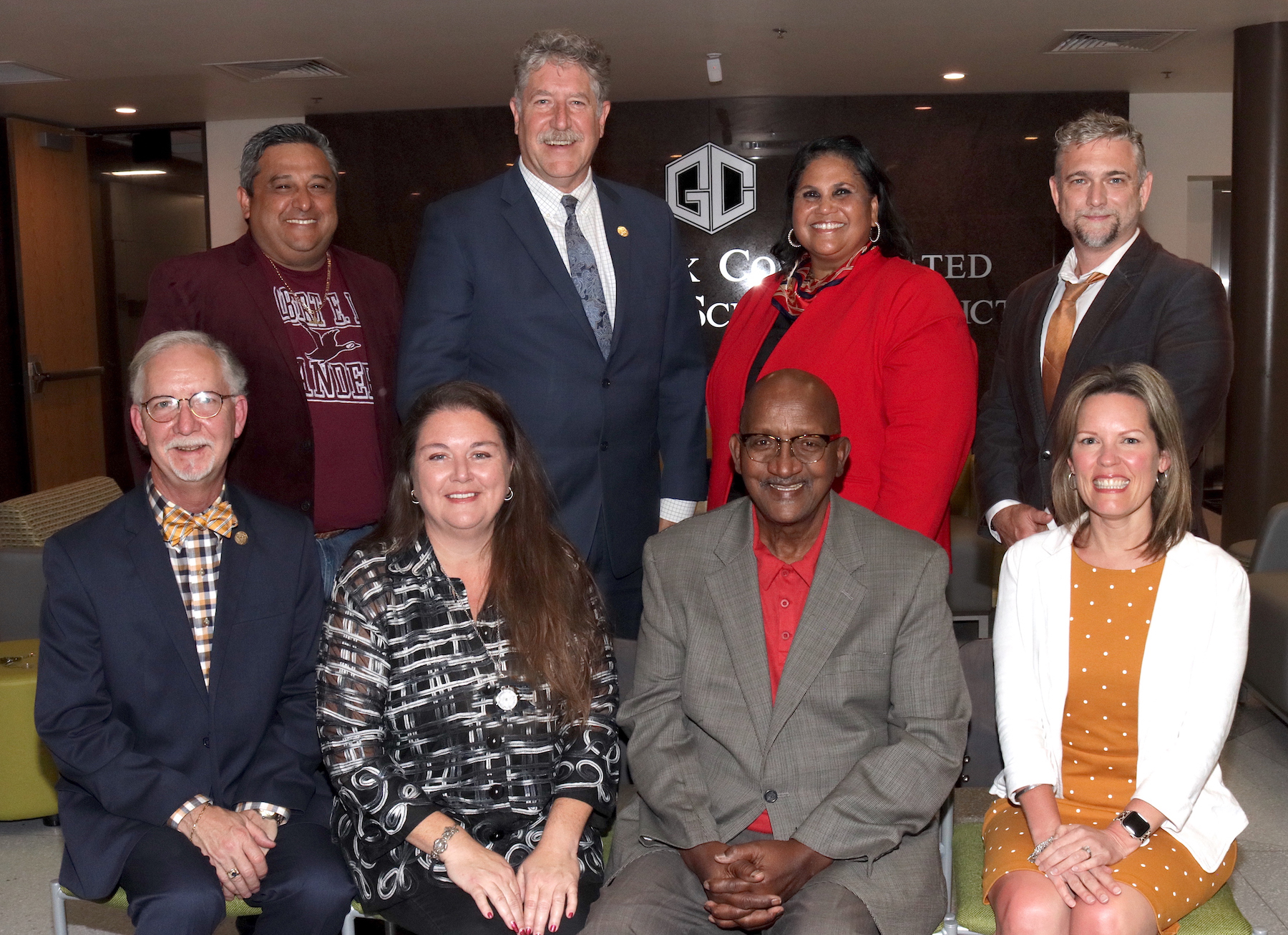 goose creek cisd school board members and superintendent pose in the admin building atrium