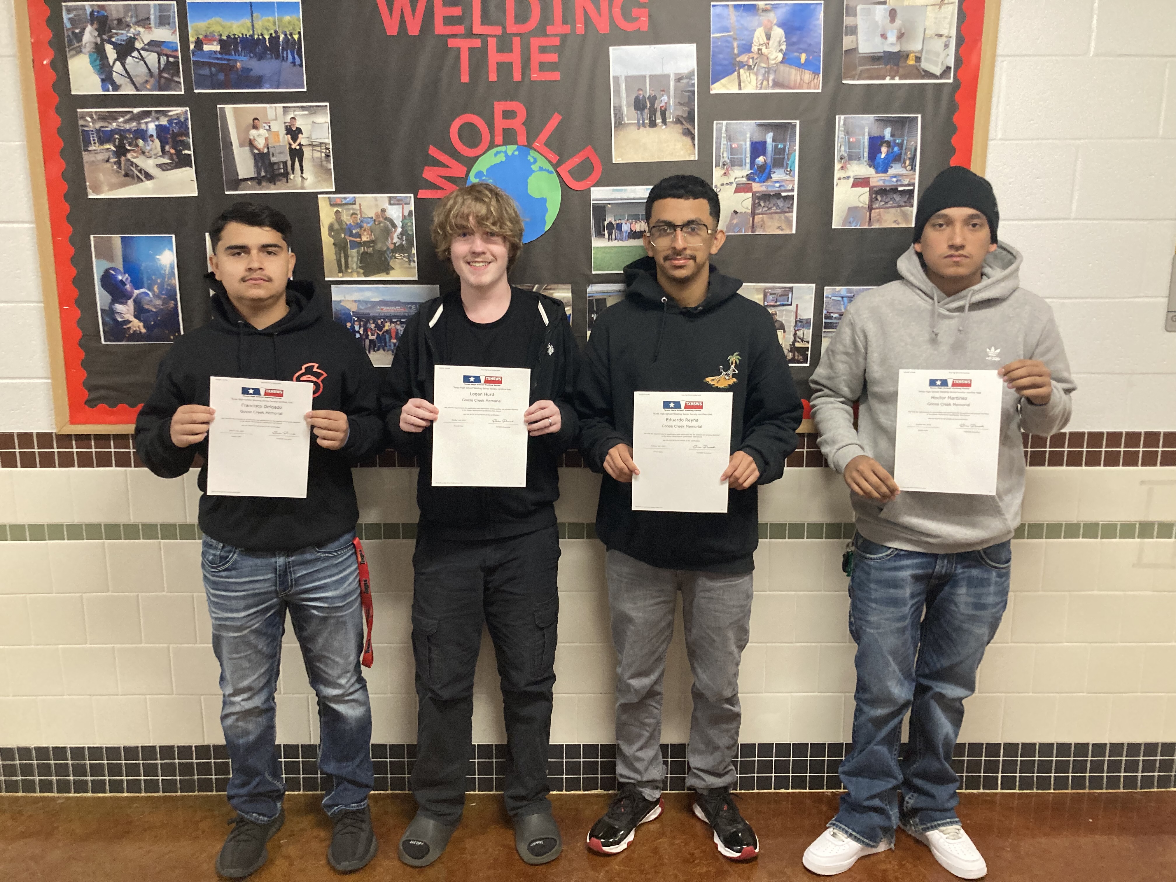Welding students pose with their awards