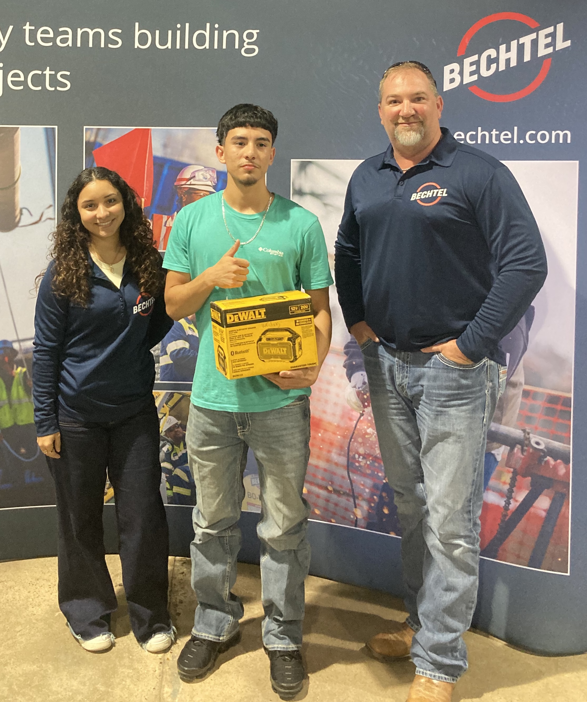 welding student poses with bluetooth speaker