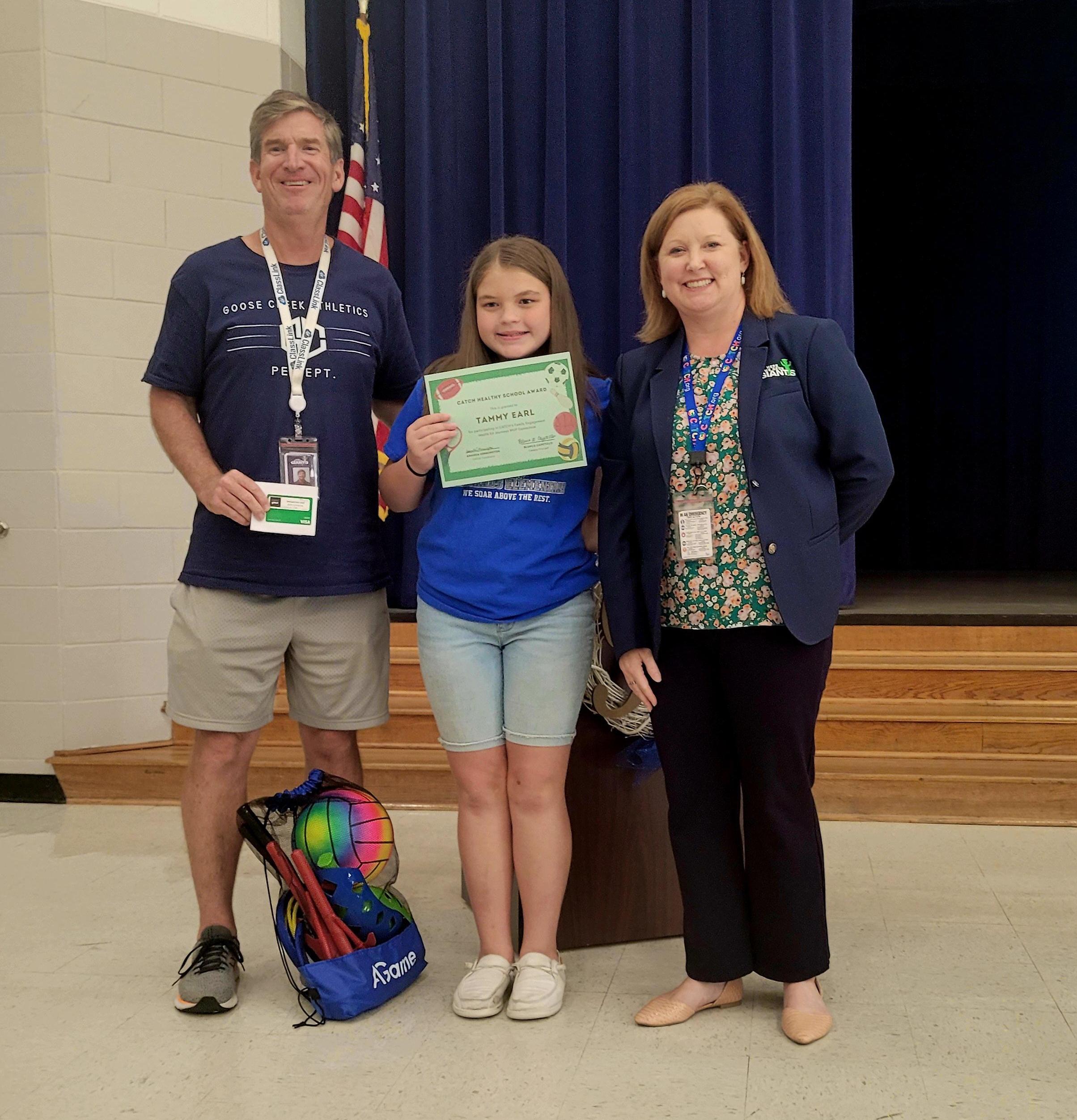 amanda kennington presents highlands elementary coach and student with CATCH donation