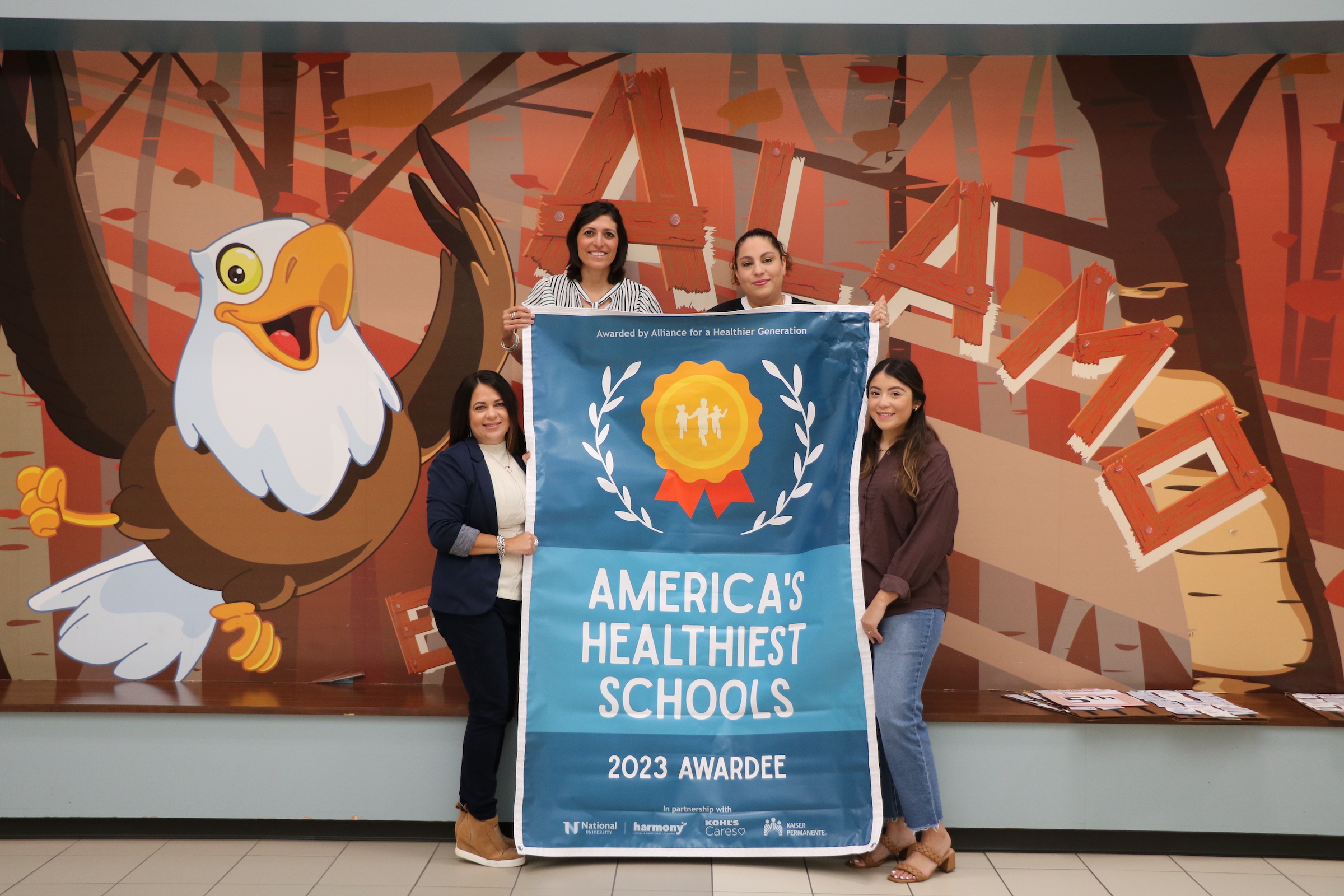 Alamo elementary poses with americas healthiest schools banner