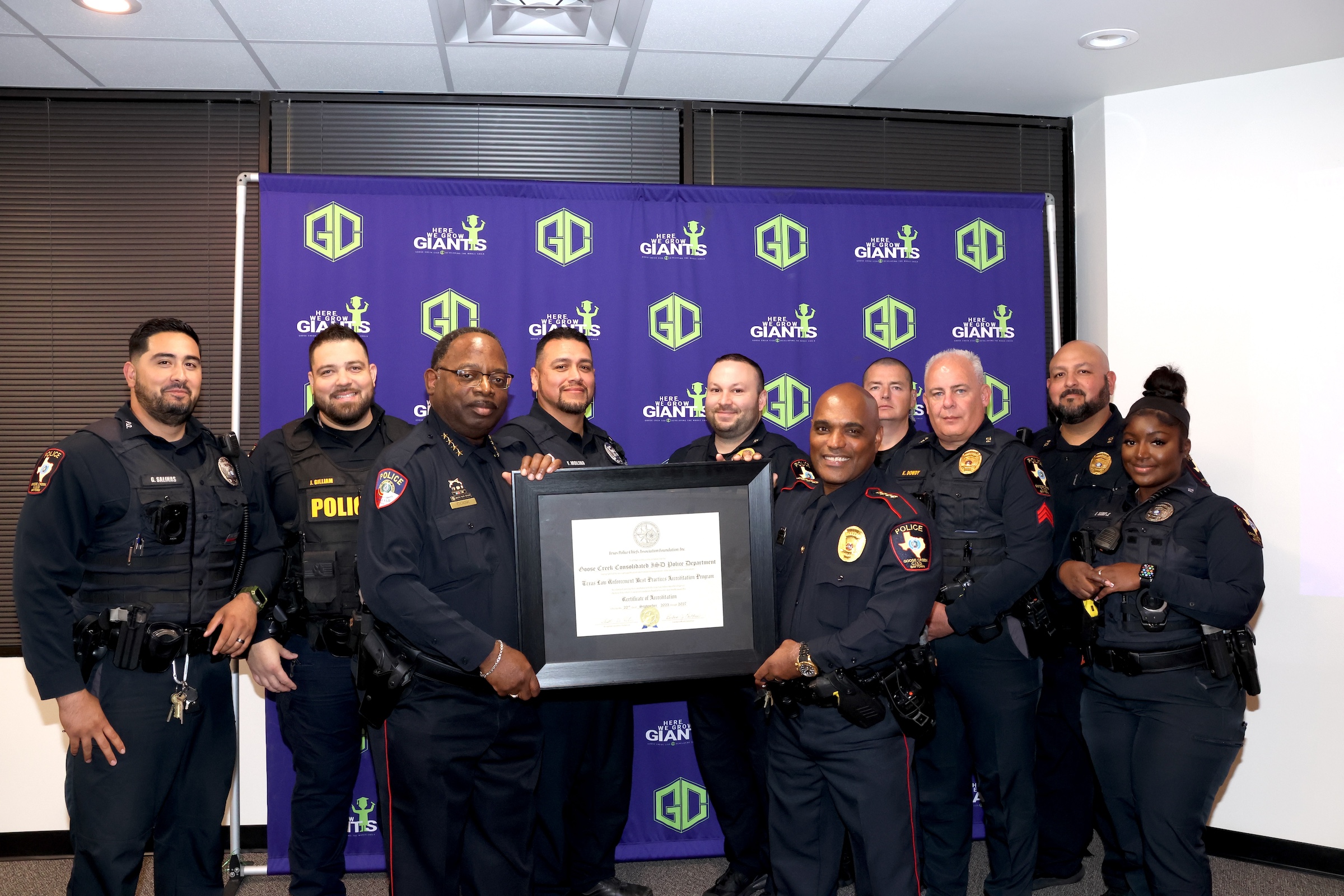 Police department and humble isd chief pose with award
