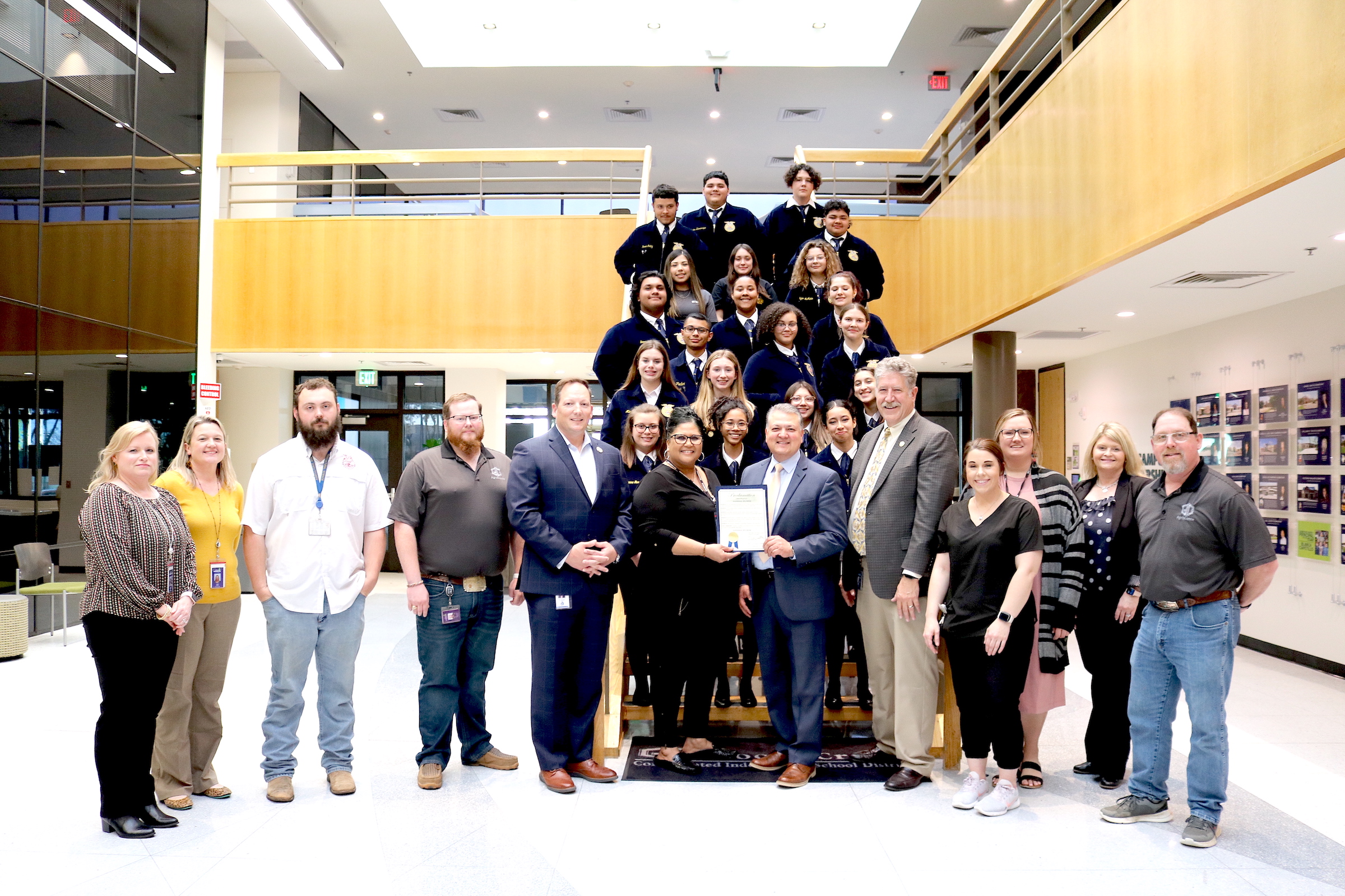 City officials with superintendent obrien and board member berrott tims pose with proclomation