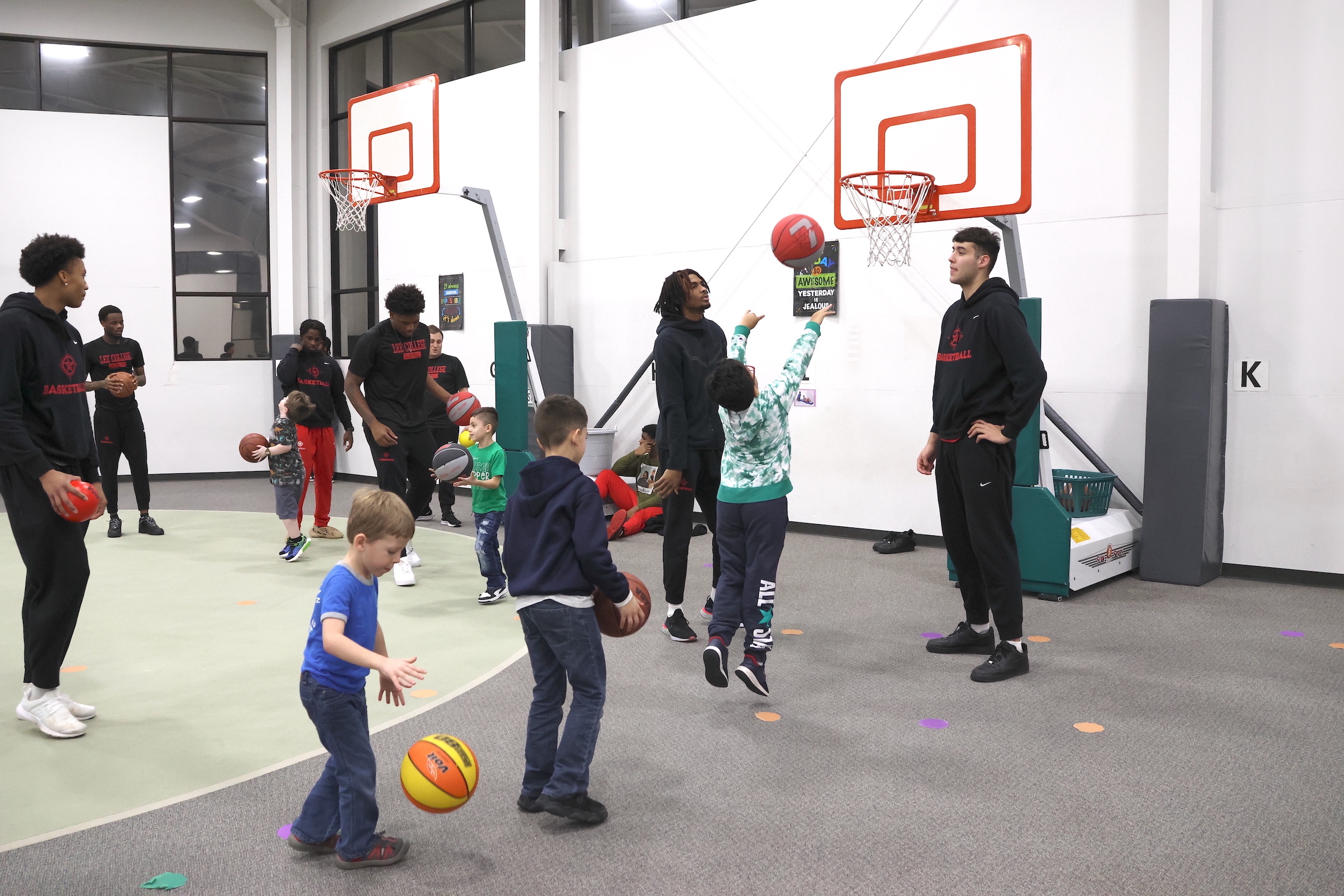 lee college basketball team playing basketball with hopper students