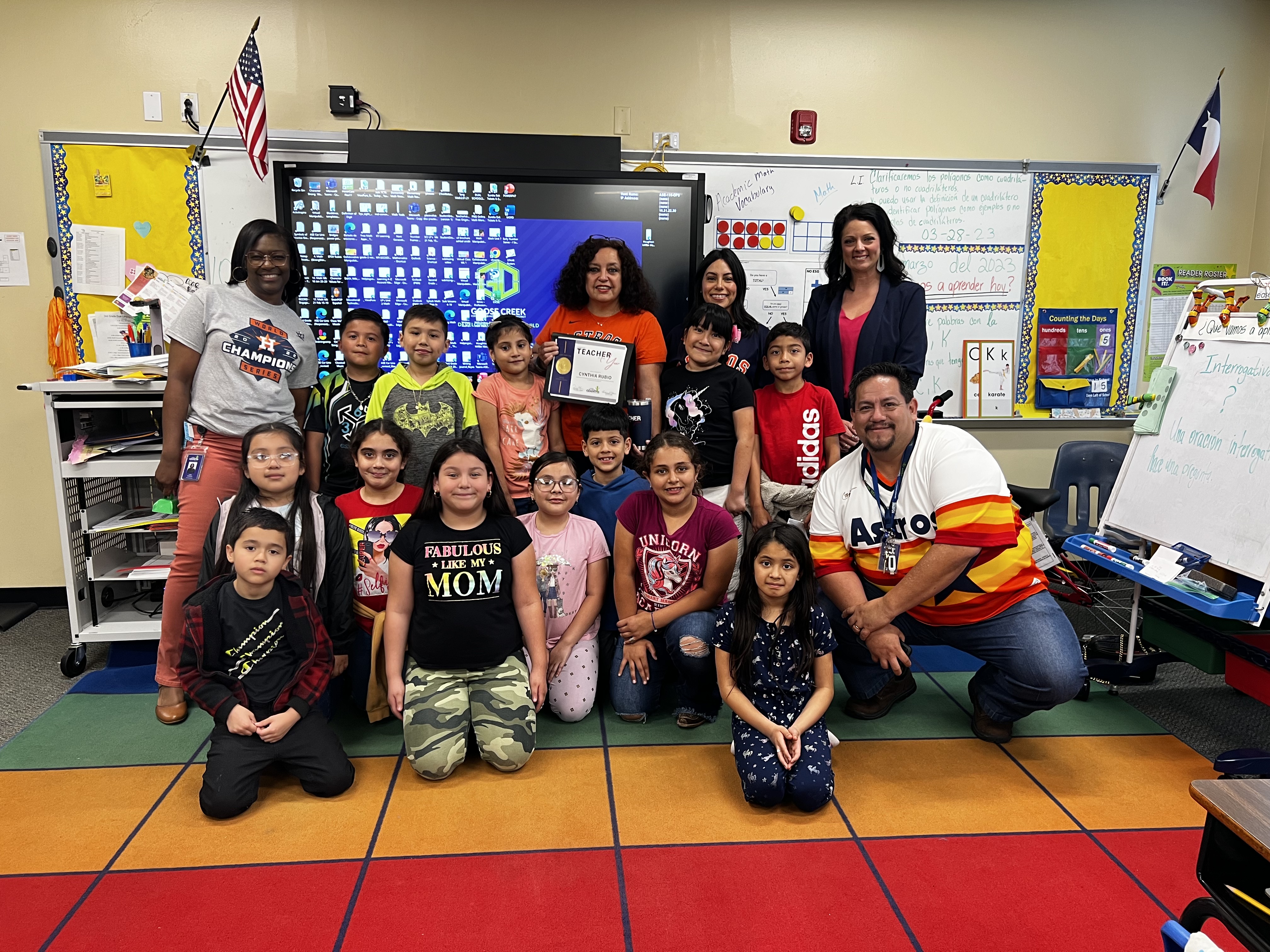 teacher of the year poses with students and administrators