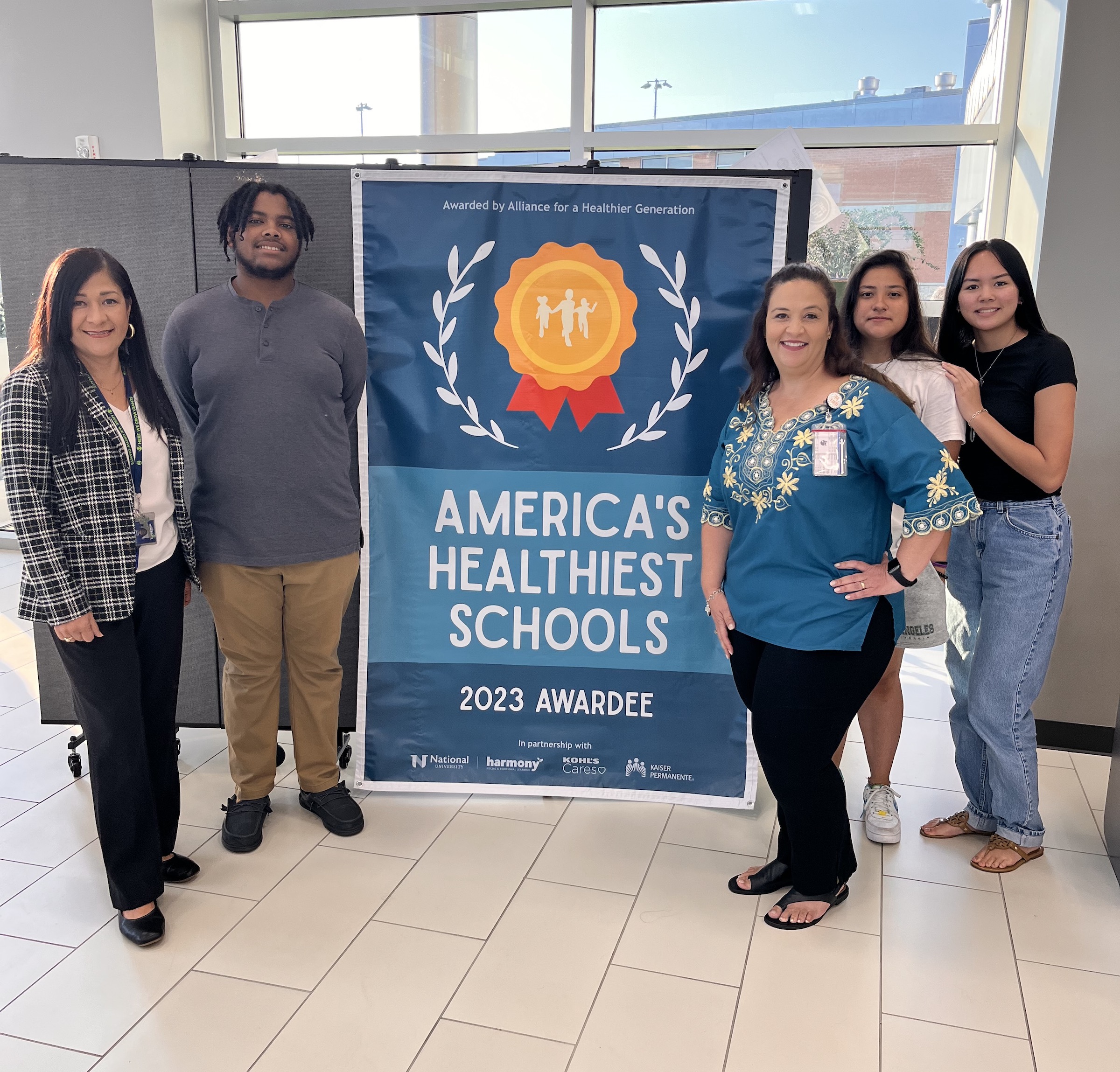 Impact ECHS poses with americas healthiest schools banner
