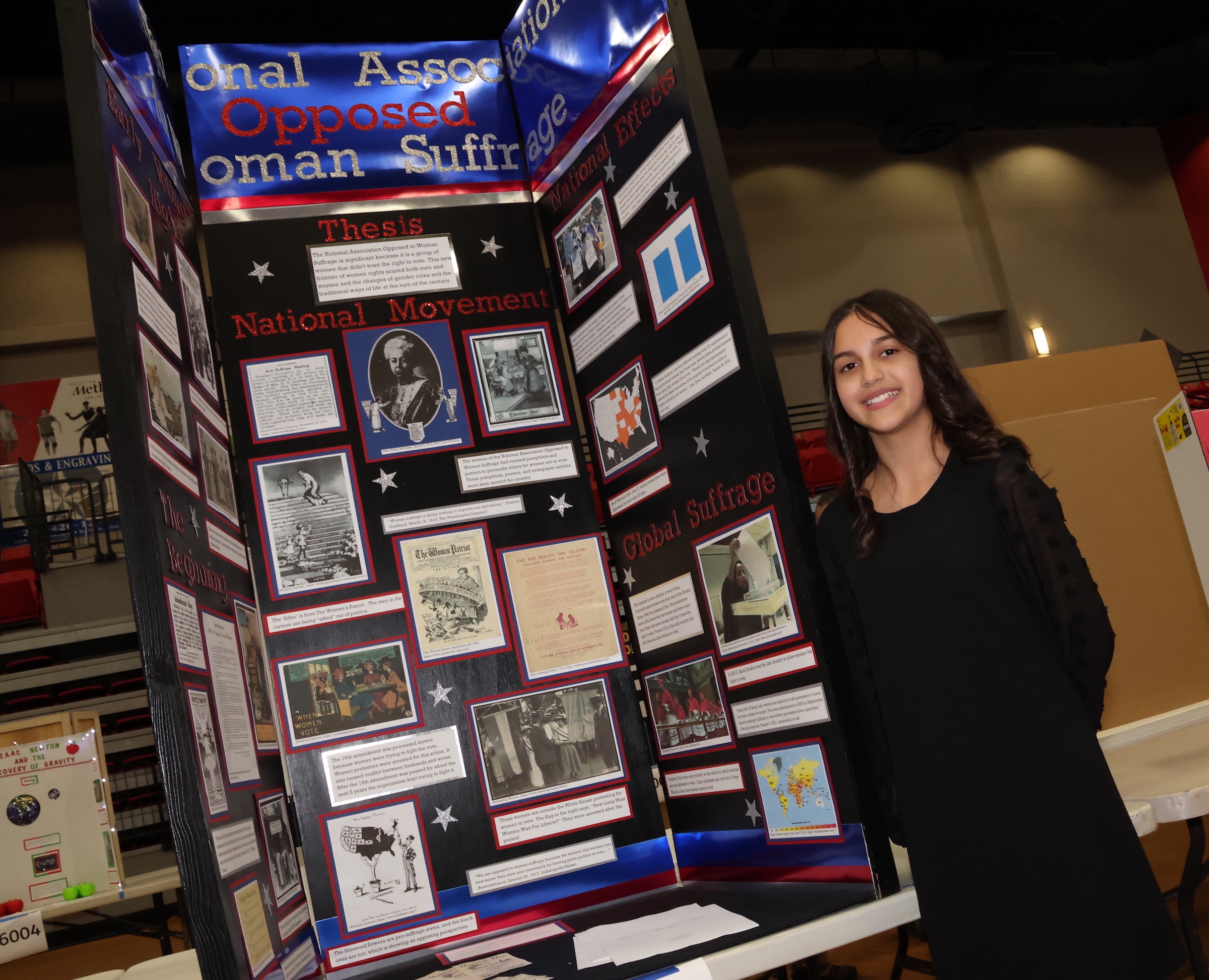 student fair contest poses with project board