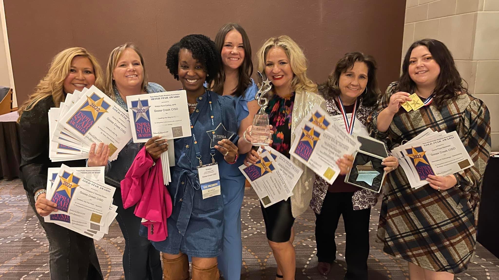 Community Engagement Team poses with awards and platinum trophy