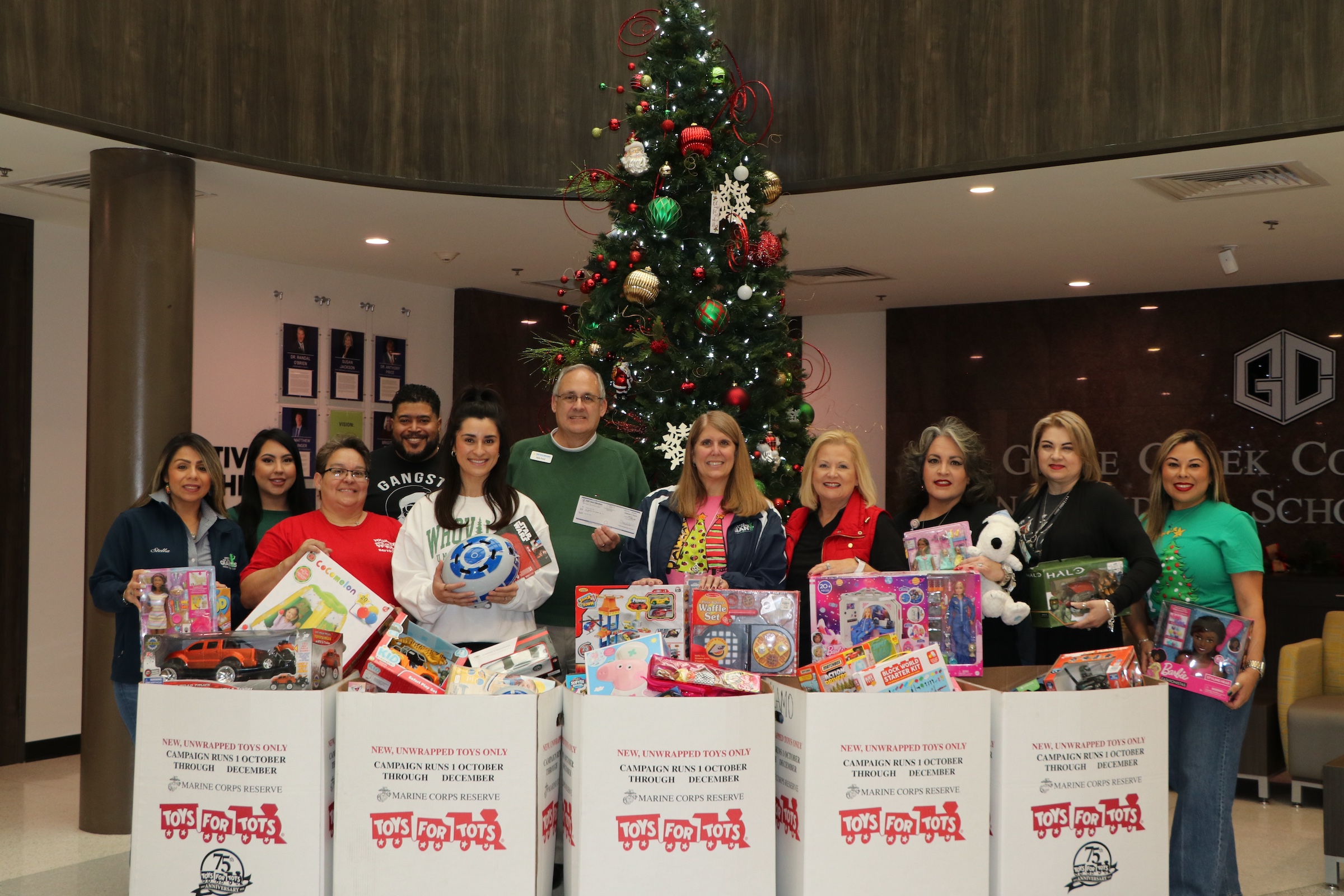 toys from tots, faith family first, gulf coast educators fcu, and toys for tots reps pose with toys