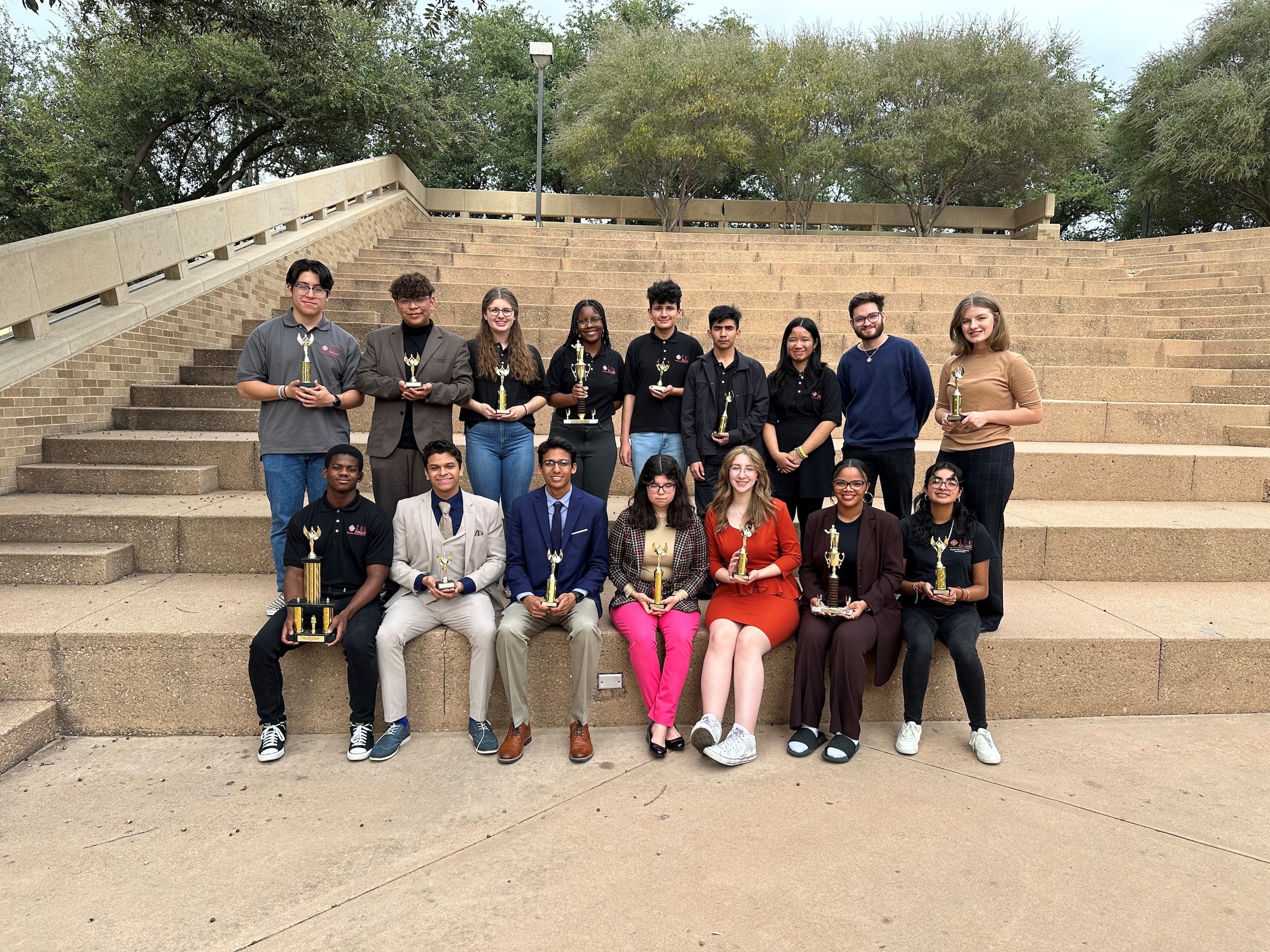 debate team poses on steps