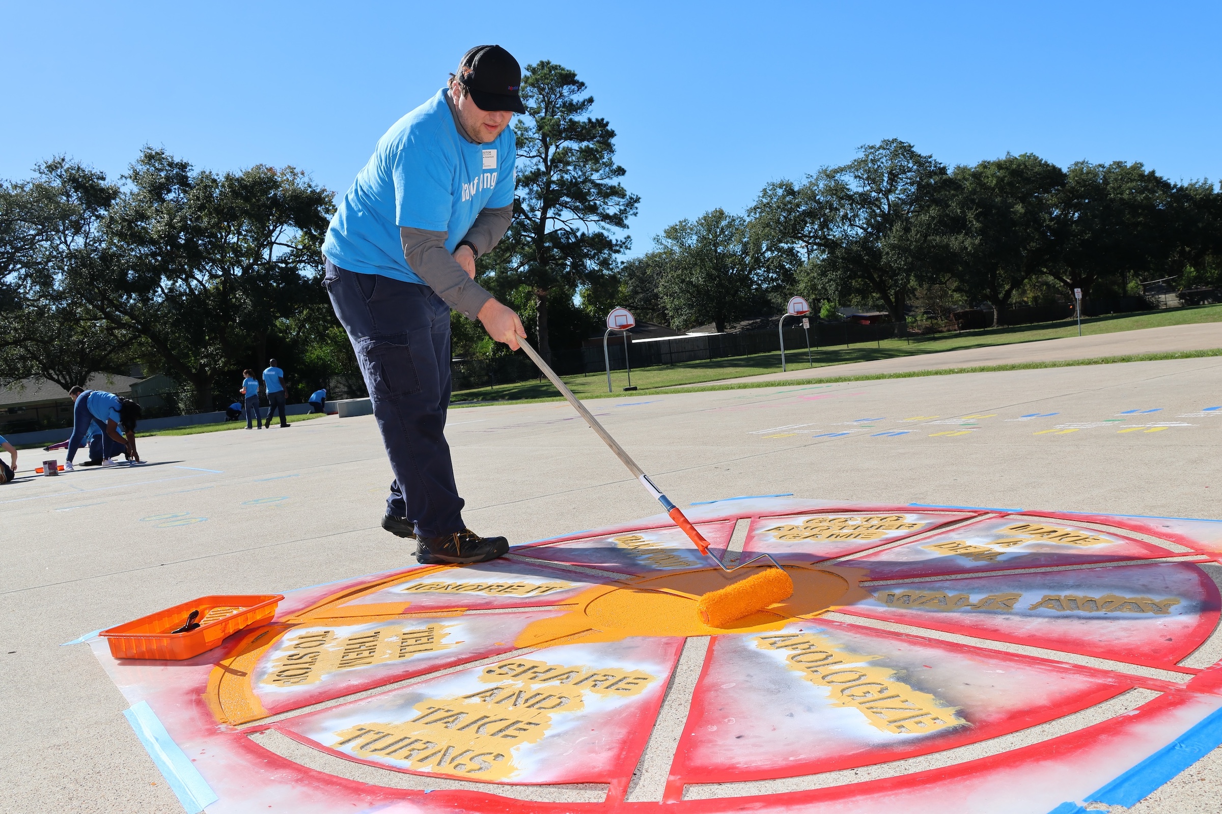 exxonmobil volunteer at bowie painting the playground