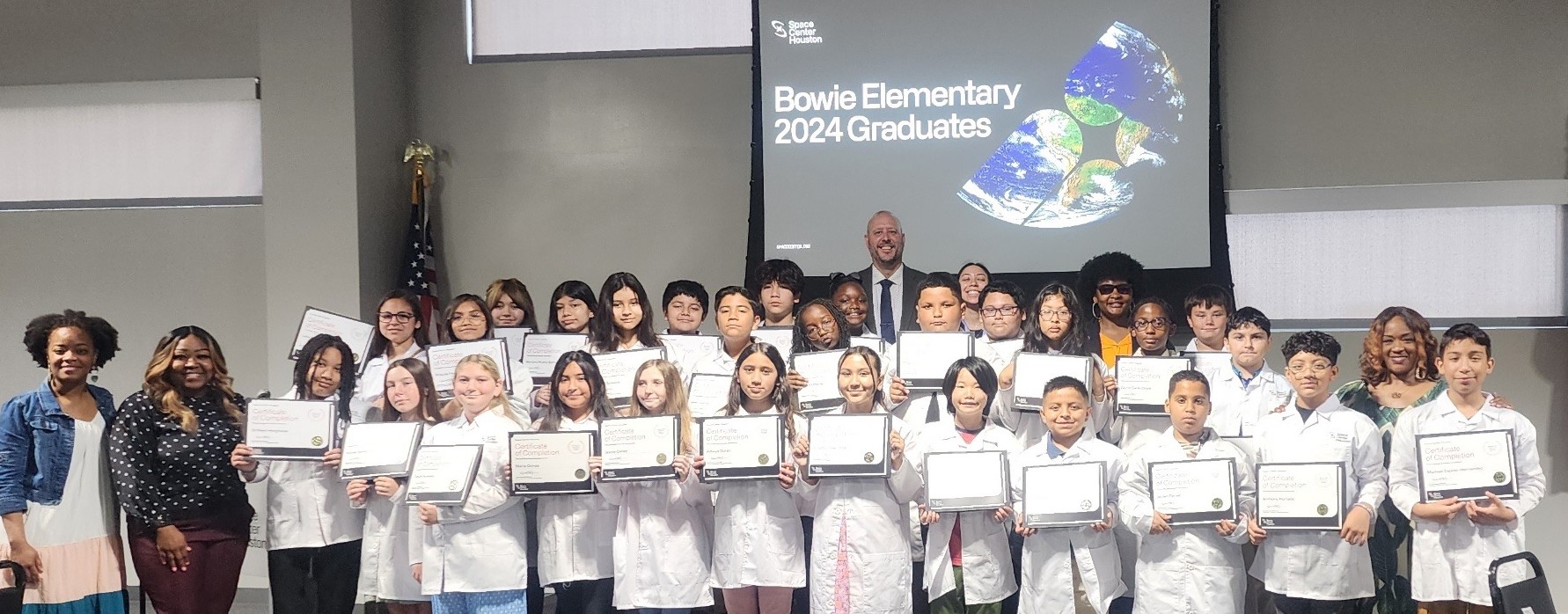 Bowie elementary students pose with their graduation certificates.