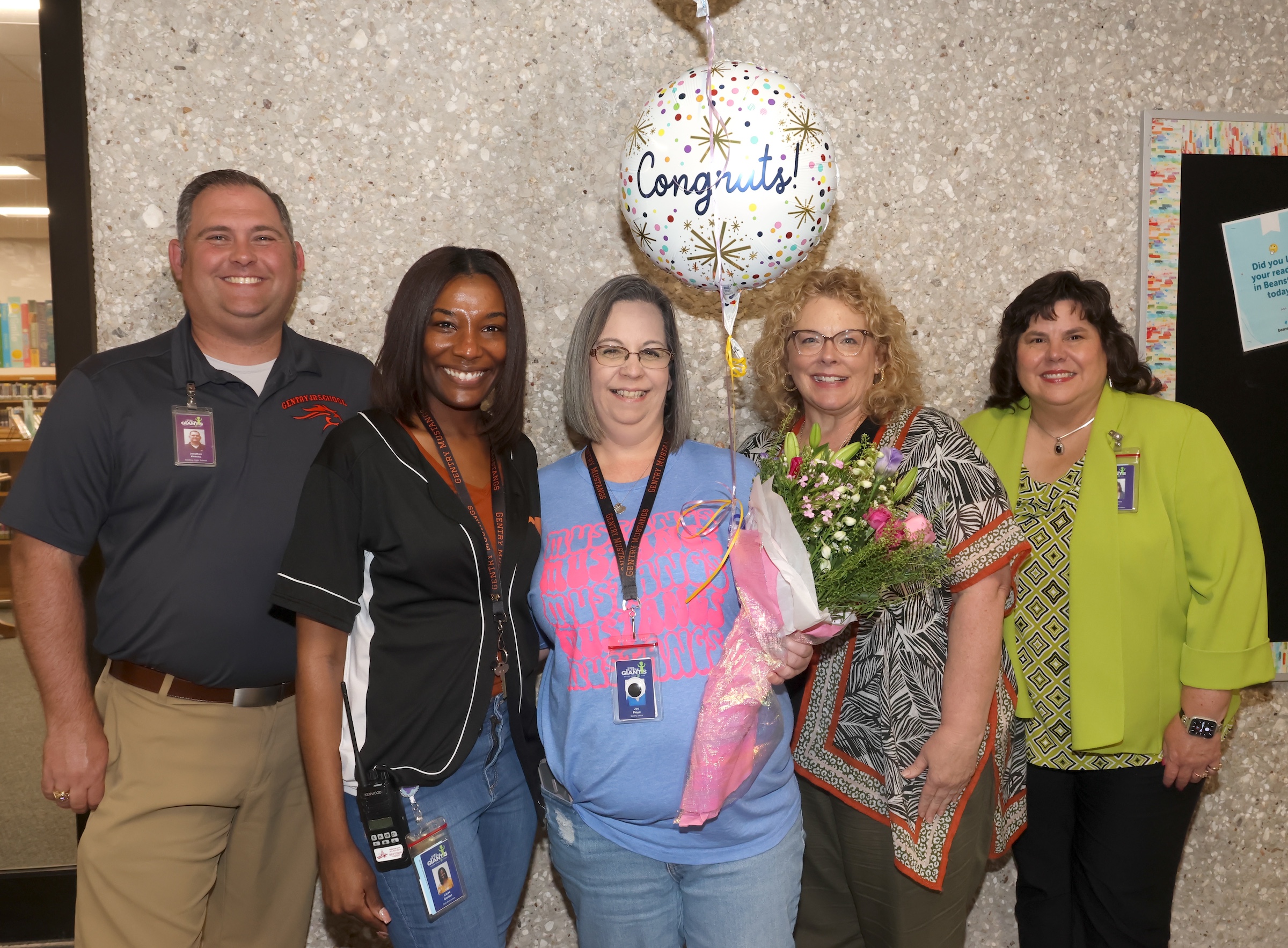 Joy Floyd poses with flowers and administrators