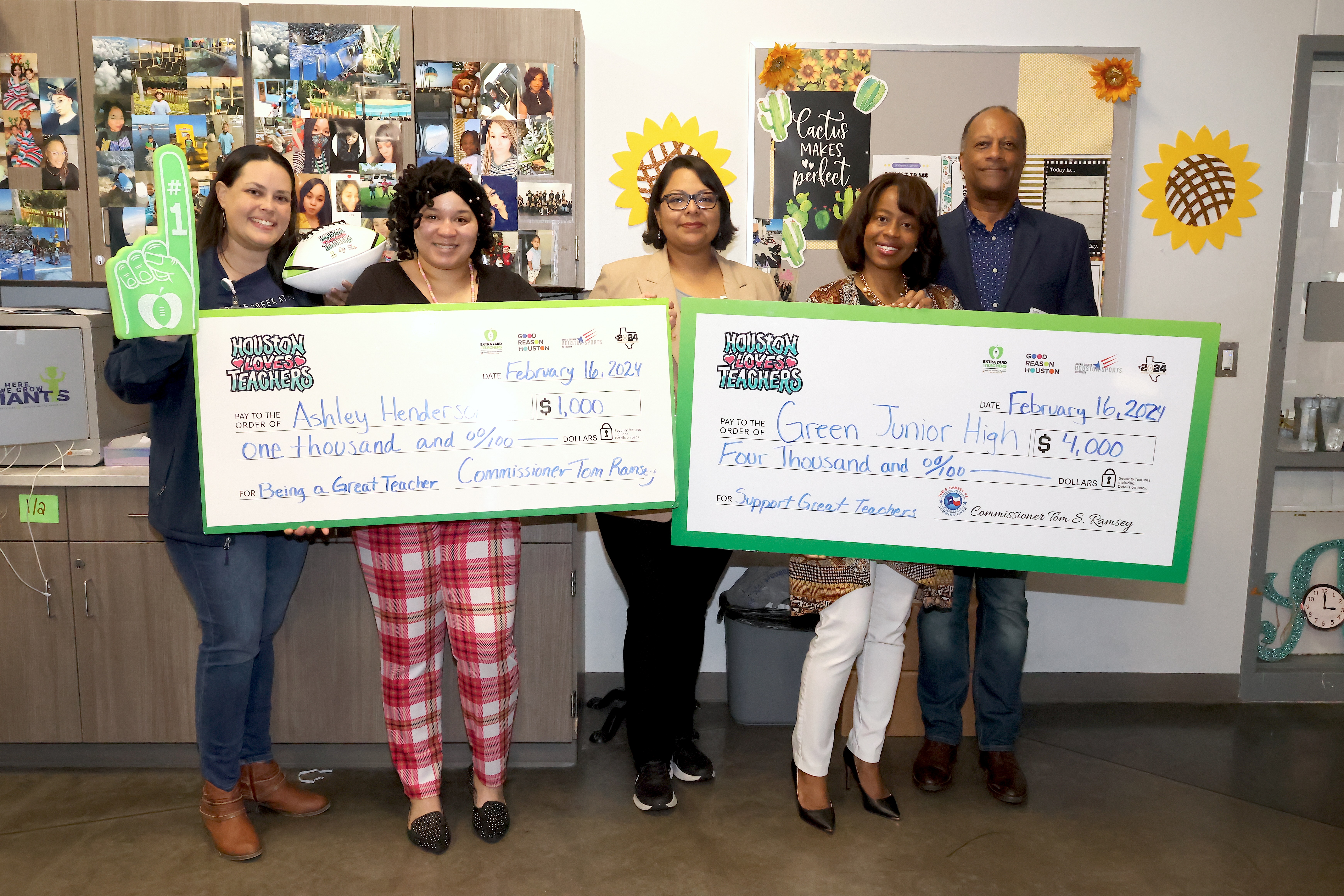 Harris County representatives and district leaders pose with principal, teacher, and checks