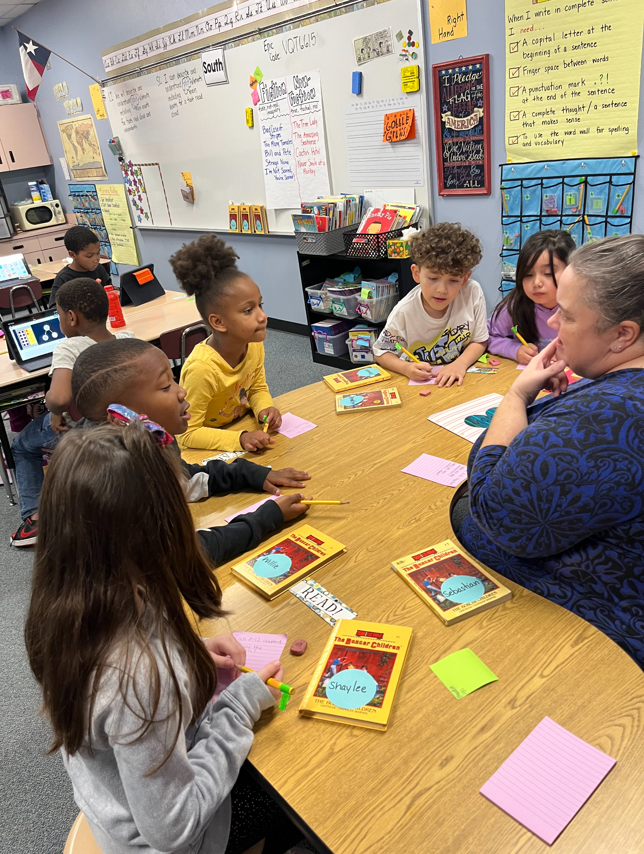 teachers works with students on first day back from break