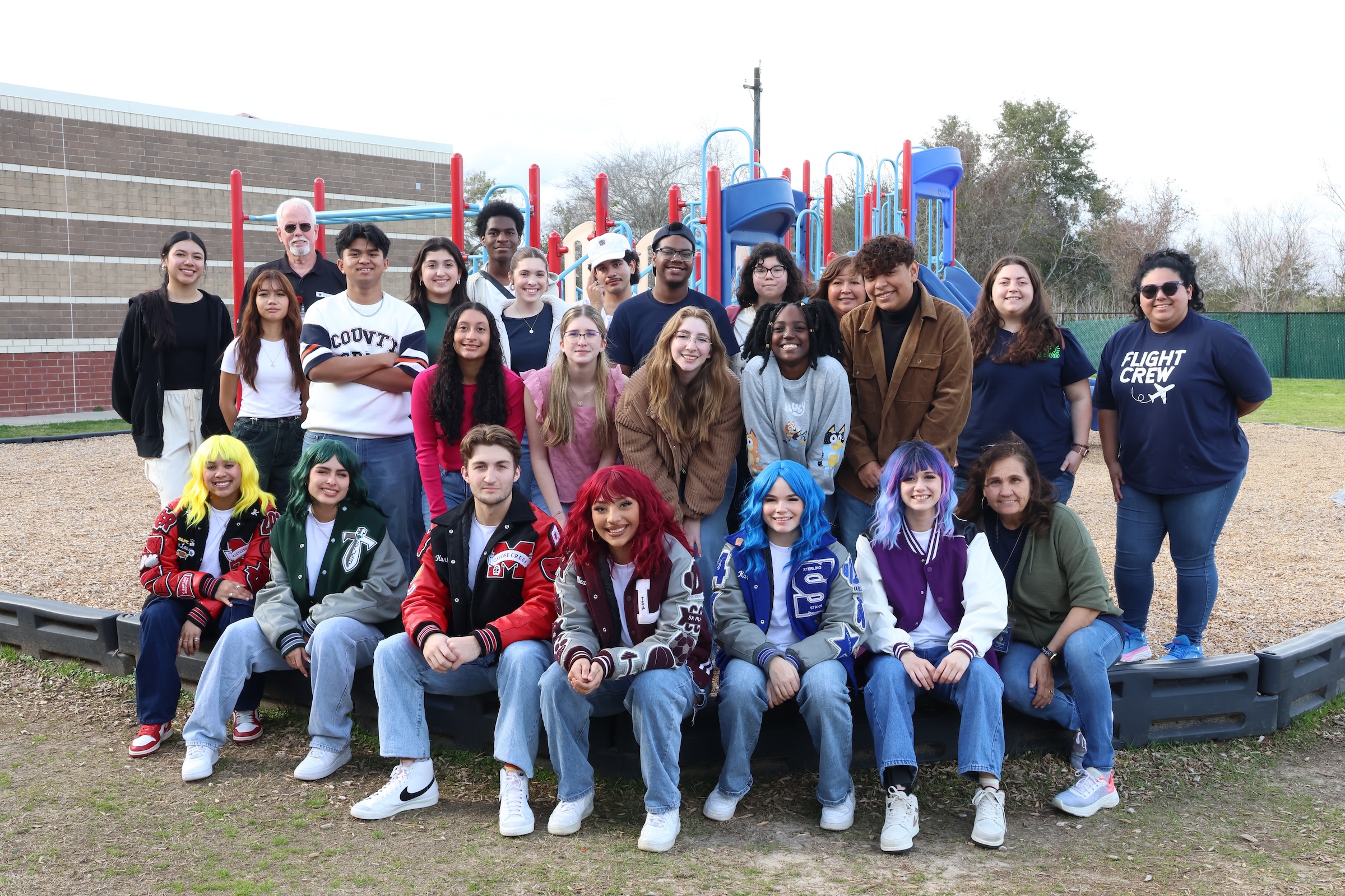 PR Squad students and sponsors pose together on playground