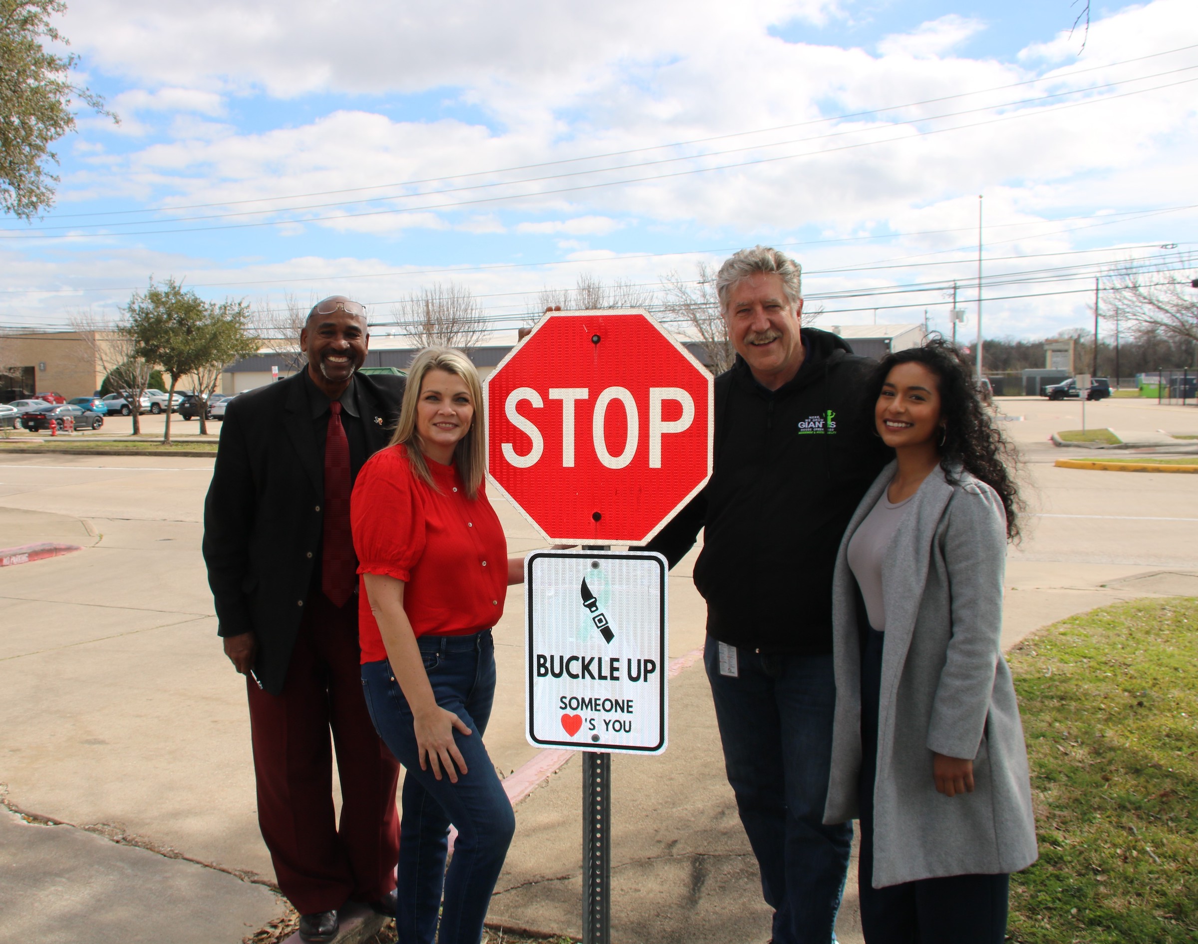 mills foundation rep, obrien, price, and state farm agent pose with sign