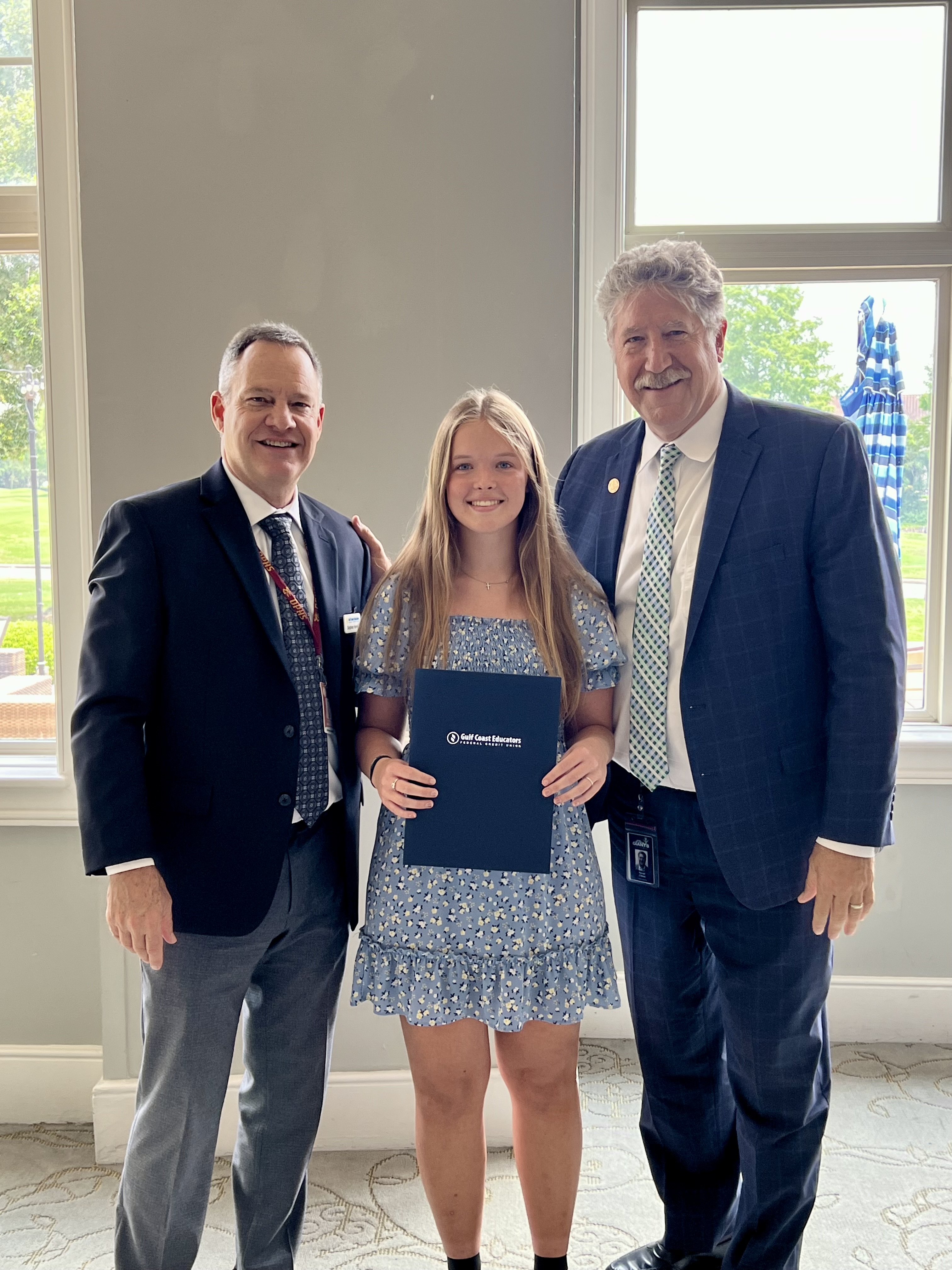 student posing with scholarship