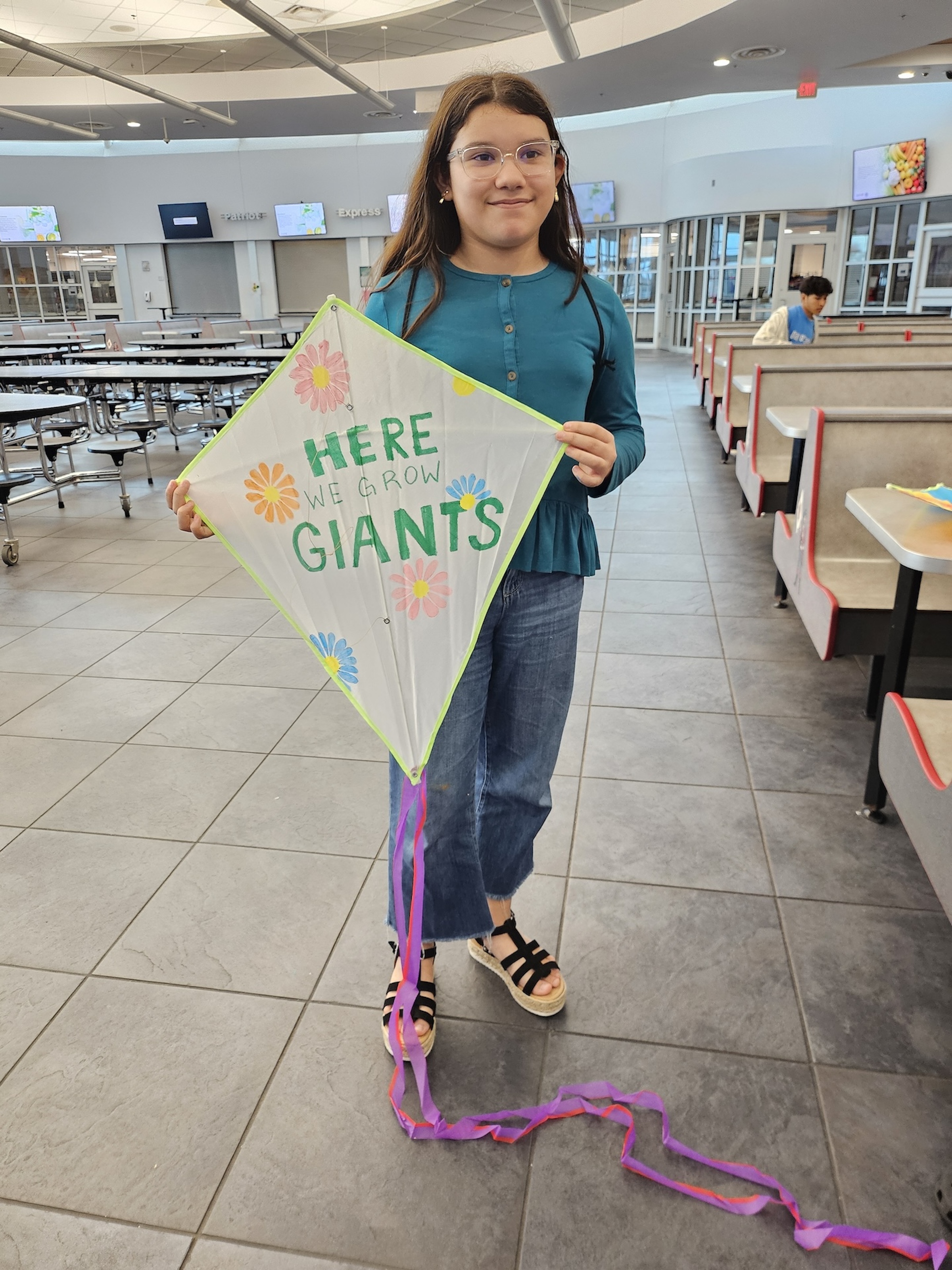 Alondra stands with her winning kite design