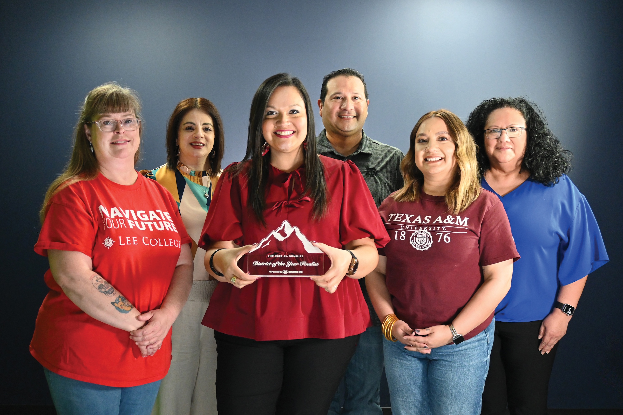 Migrant Department poses with trophy
