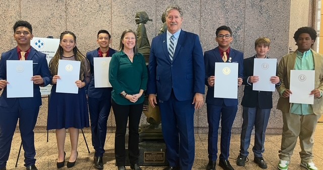 Student competitors pose with their awards and dr. randal obrien and faith longorio