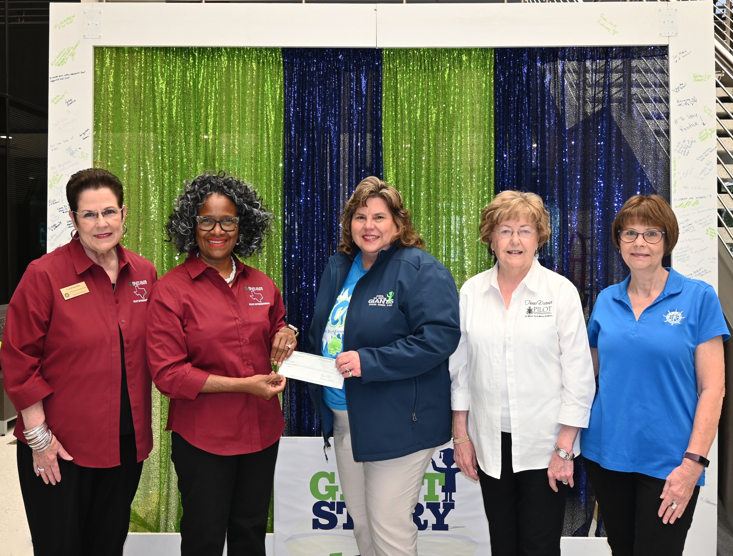 Pilot club of baytown with sped administrators holding check