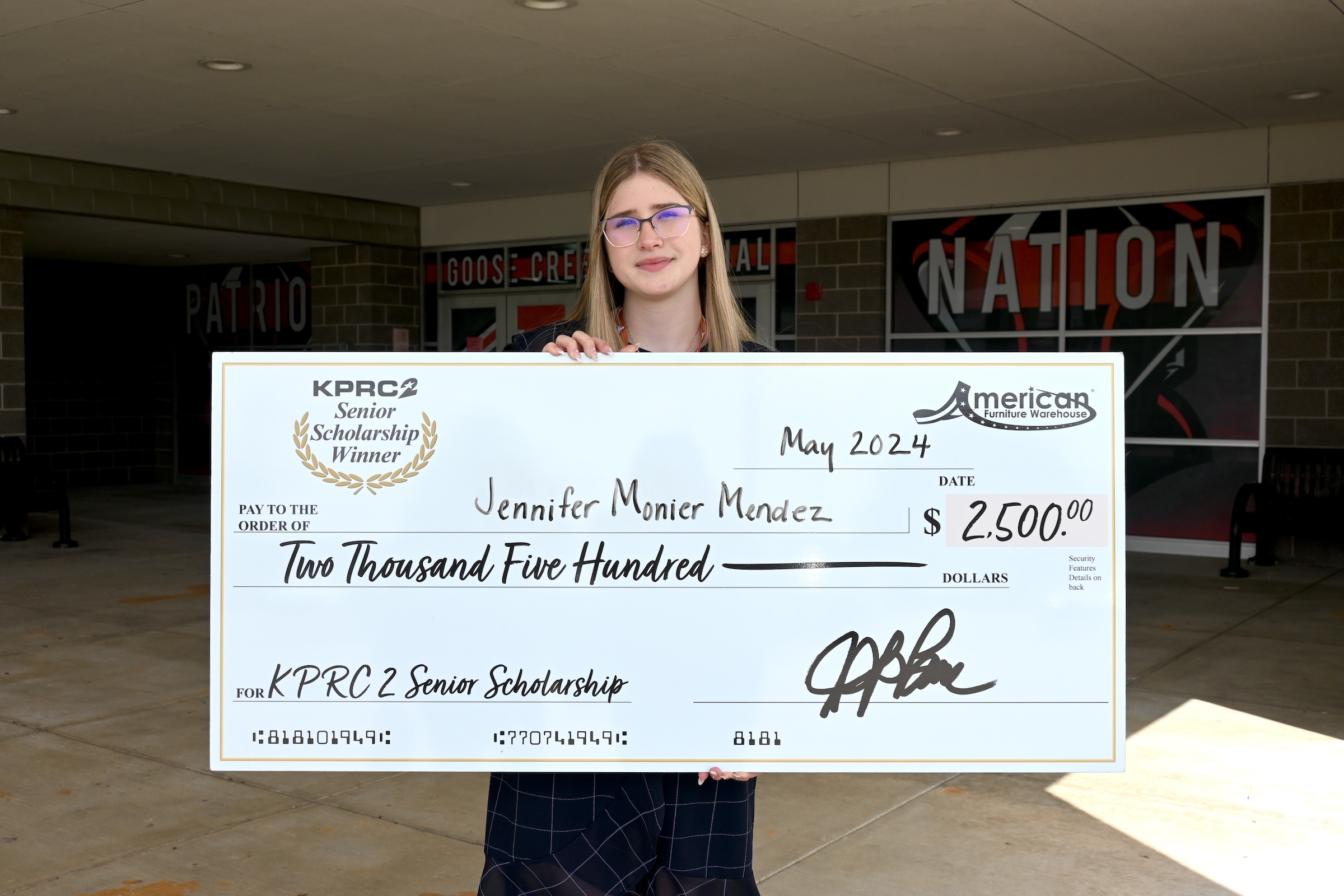 Jenny poses with scholarship check