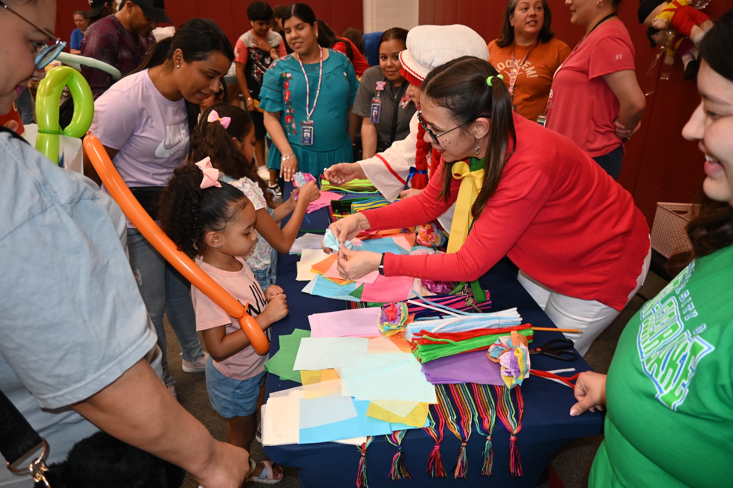 dia del nino attendees make traditional paper flowers