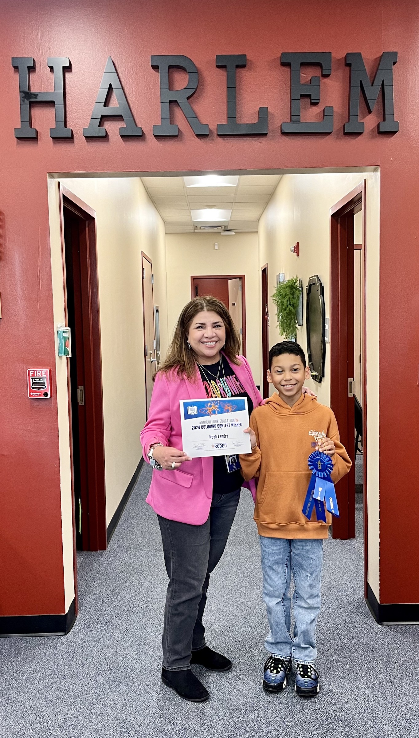 harlem winner poses with certificate