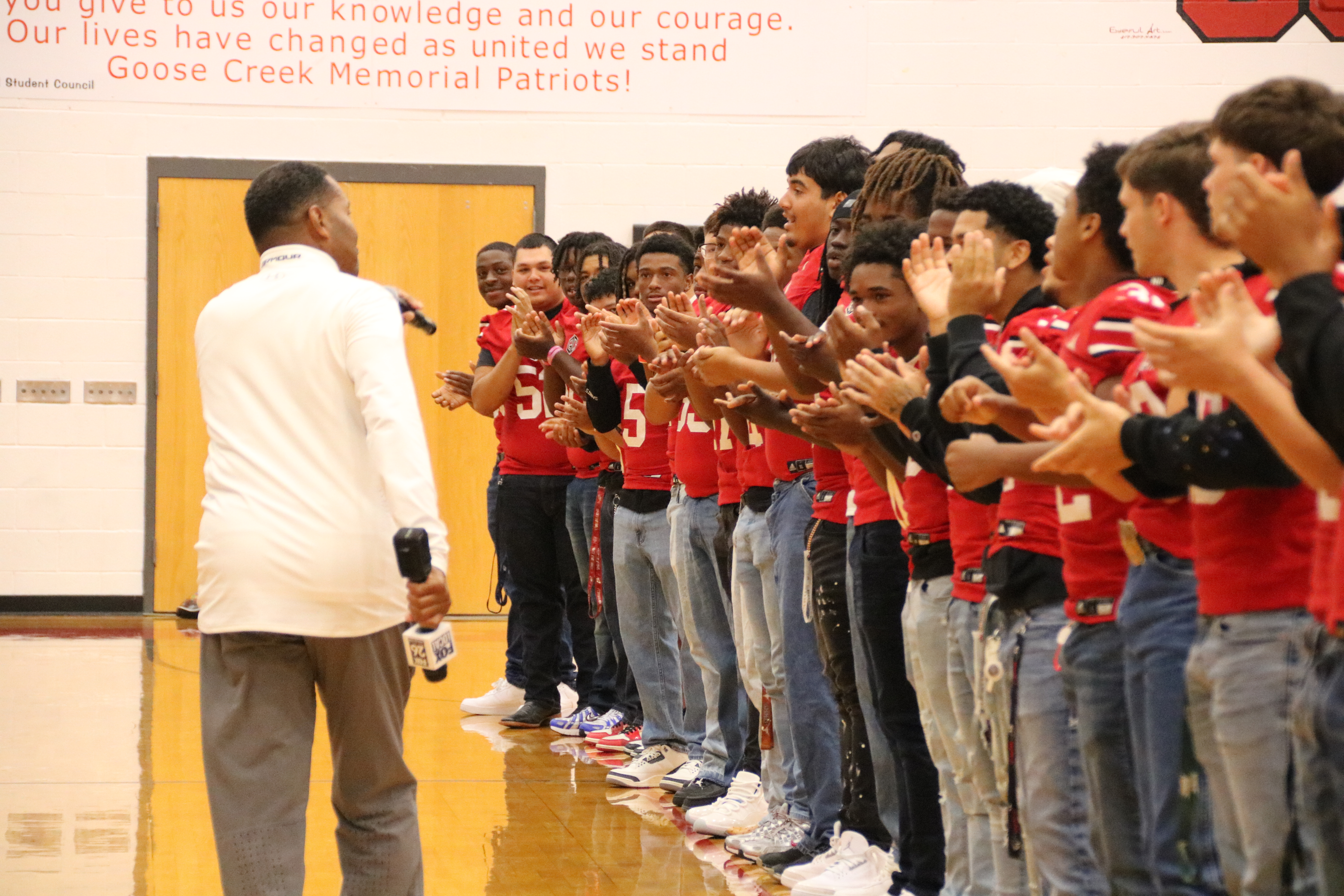 fox 26 reporter nate griffin speaks with gcm football players in the gym during broadcast