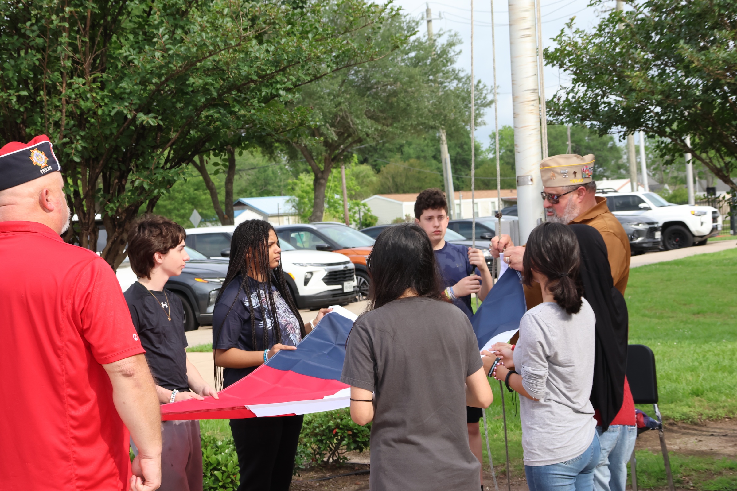 CBJ students assist Post Chaplain Jorge Gonzalez with replacing the Texas Flag.