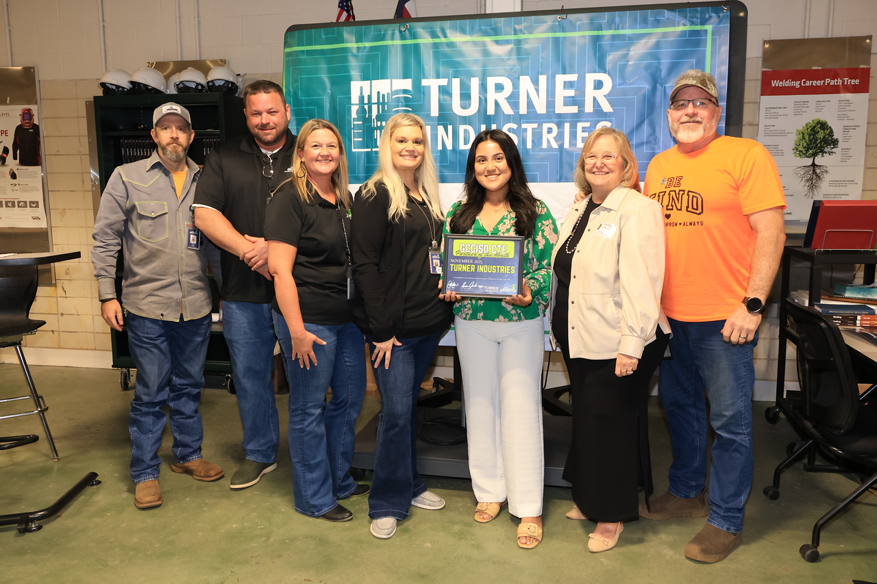 campus instructors, district admin, and turner industries reps pose with award