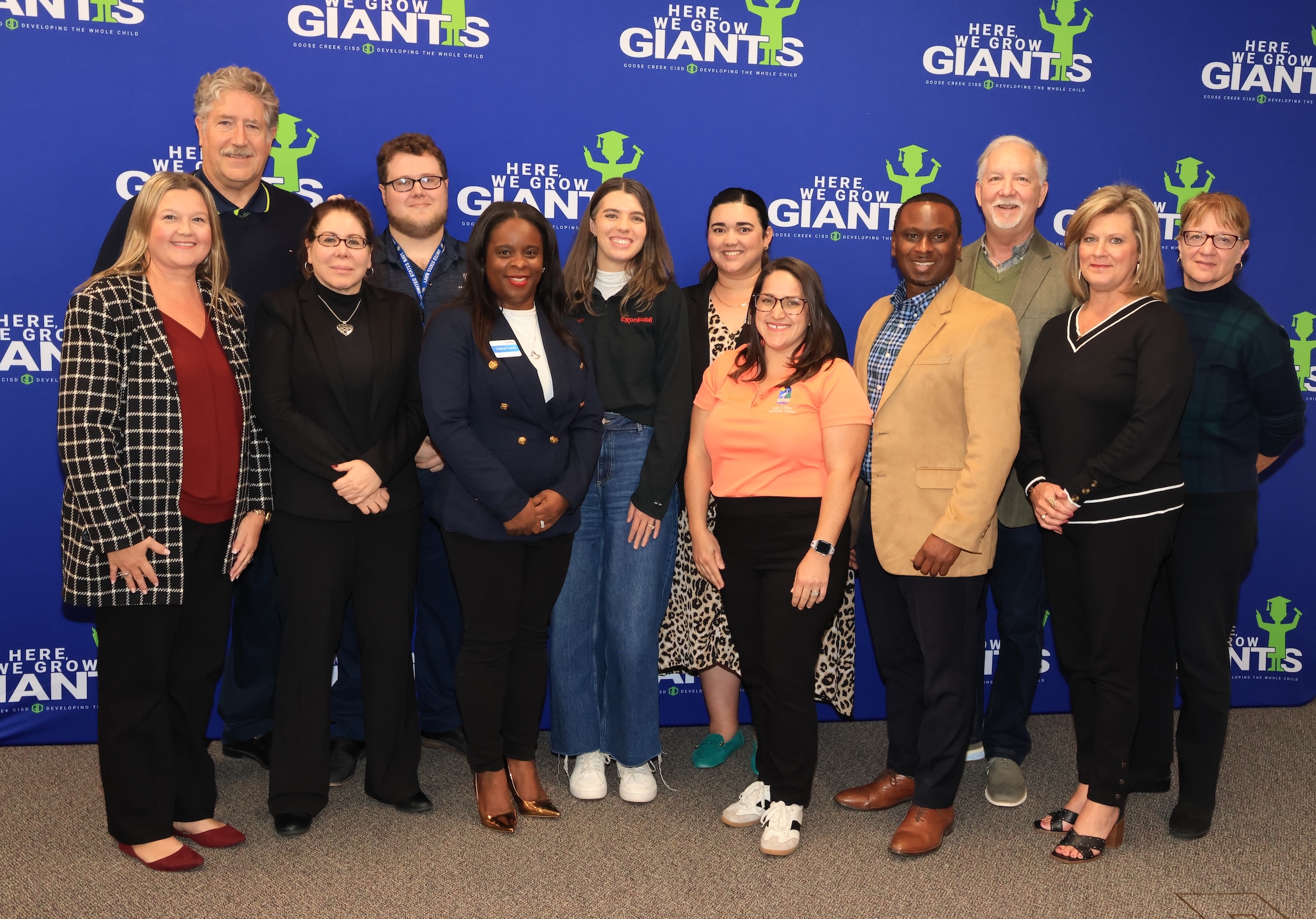 district, community, and collegiate reps pose in front of a gccisd backdrop
