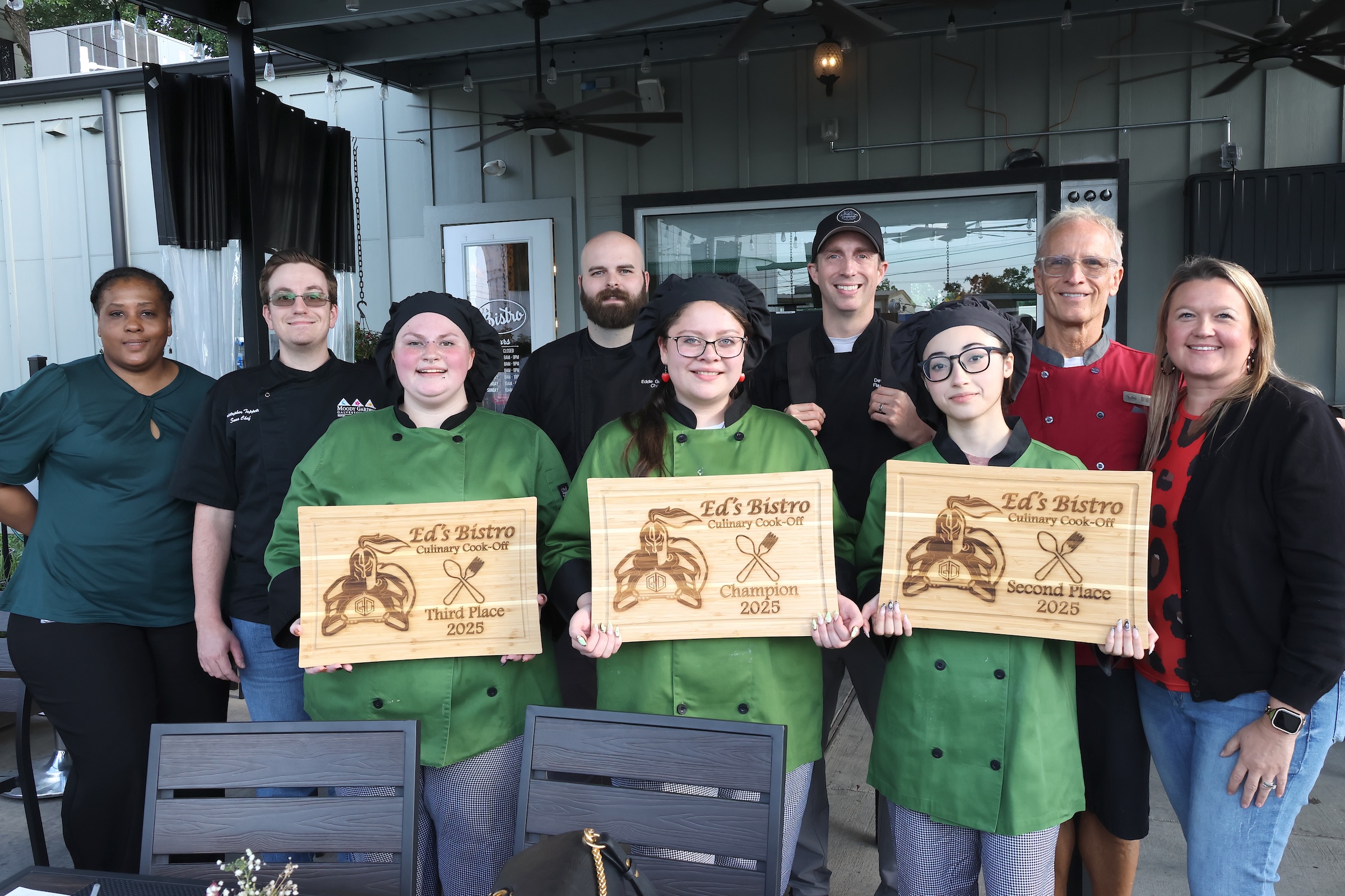 Culinary students pose with winning cutting boards