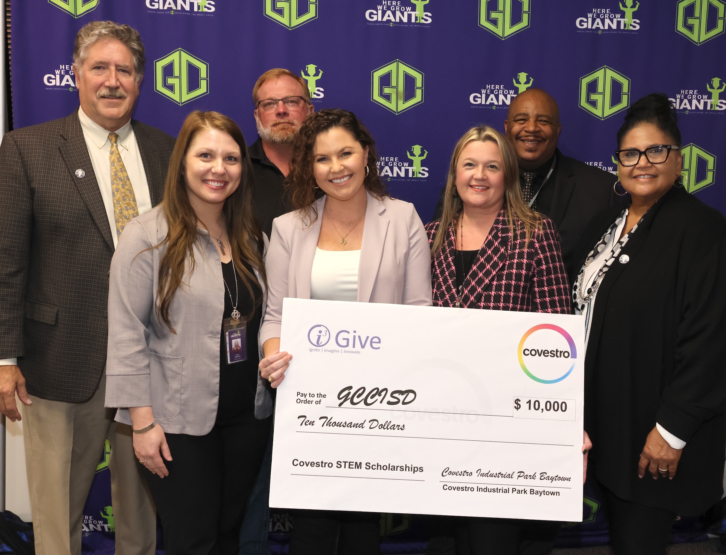 Covestro representatives and district leaders pose with check.