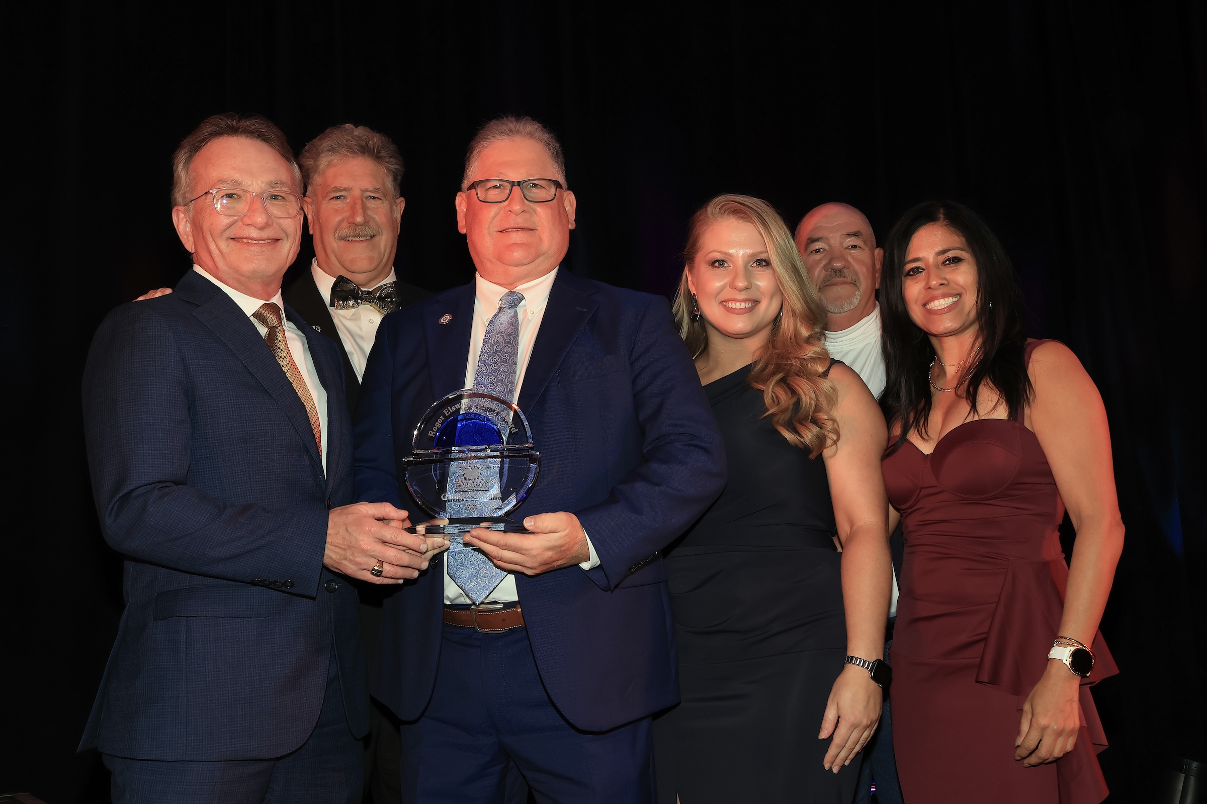 GCCISD members and award recepient pose on stage
