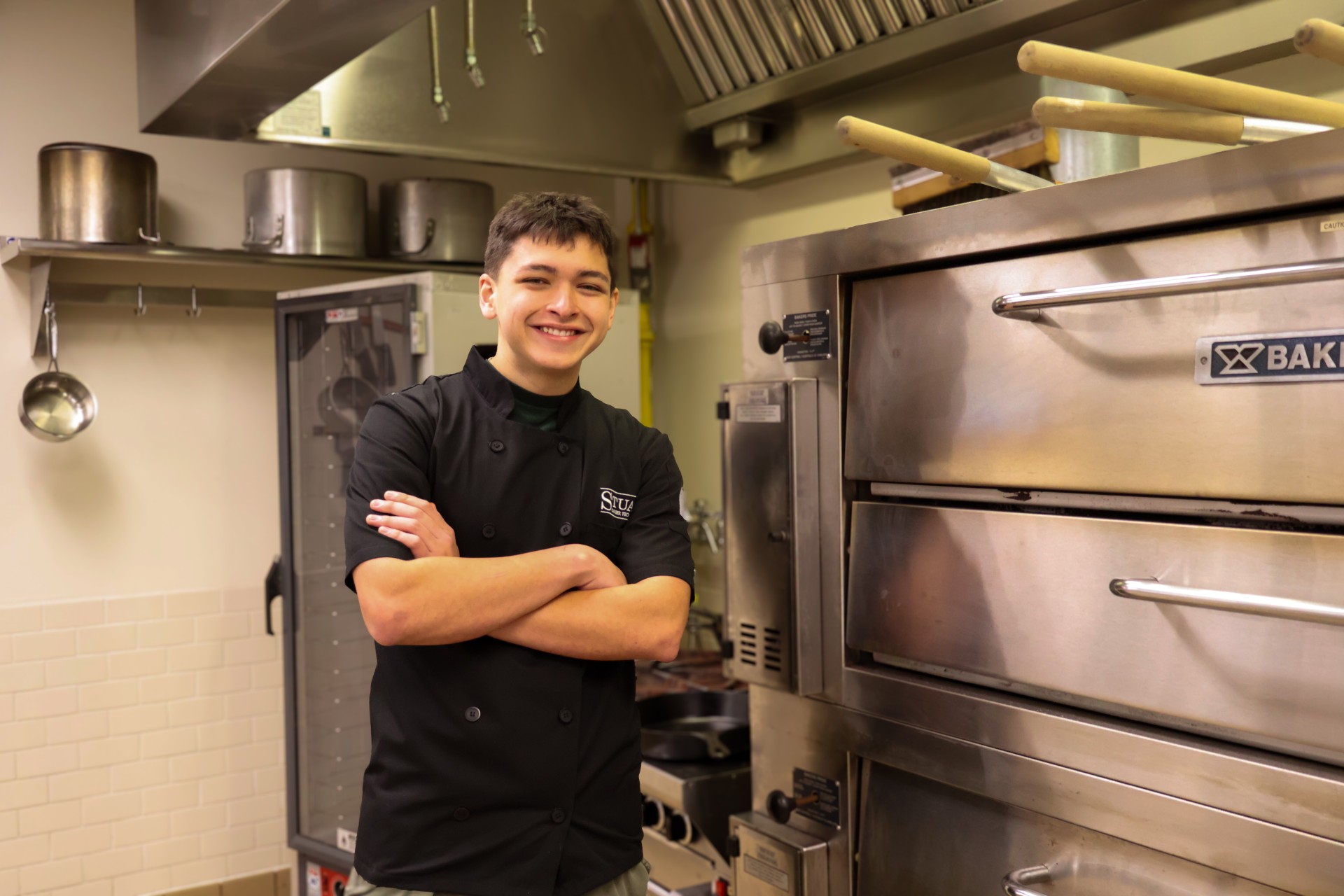 Erik Gonzalez standing in culinary kitchen