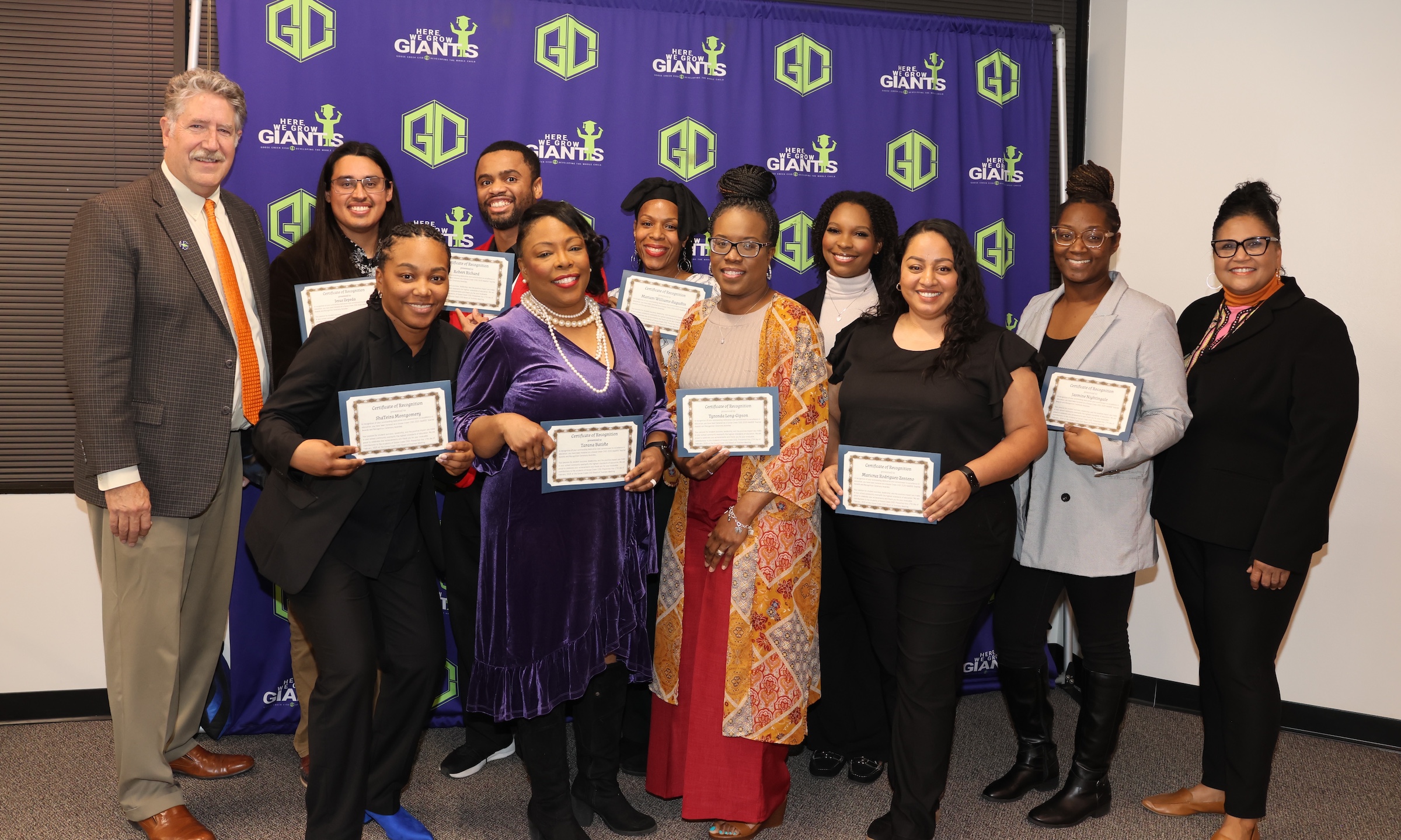 HAABSE teachers pose with district leaders at the board meeting