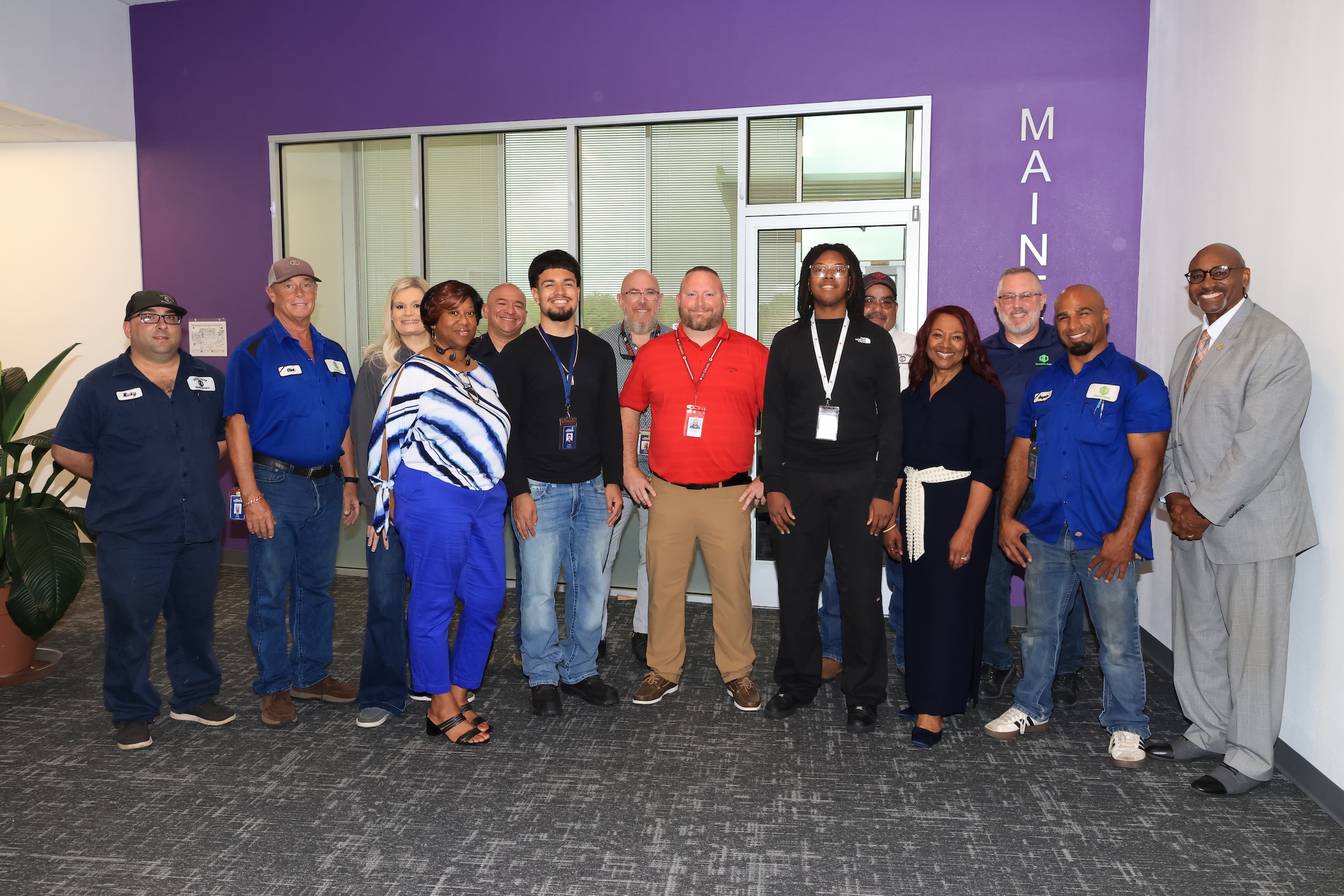 district employees, business partners, and student interns pose together for photo