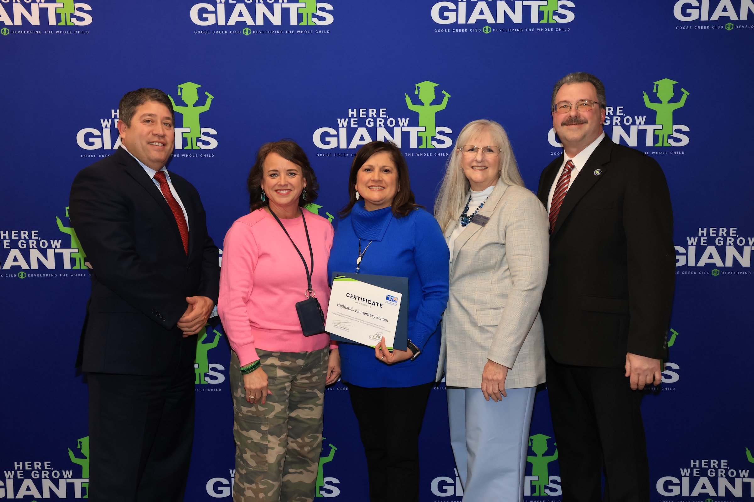 Highlands elementary representatives pose with recognition and board president and joe rodriguez