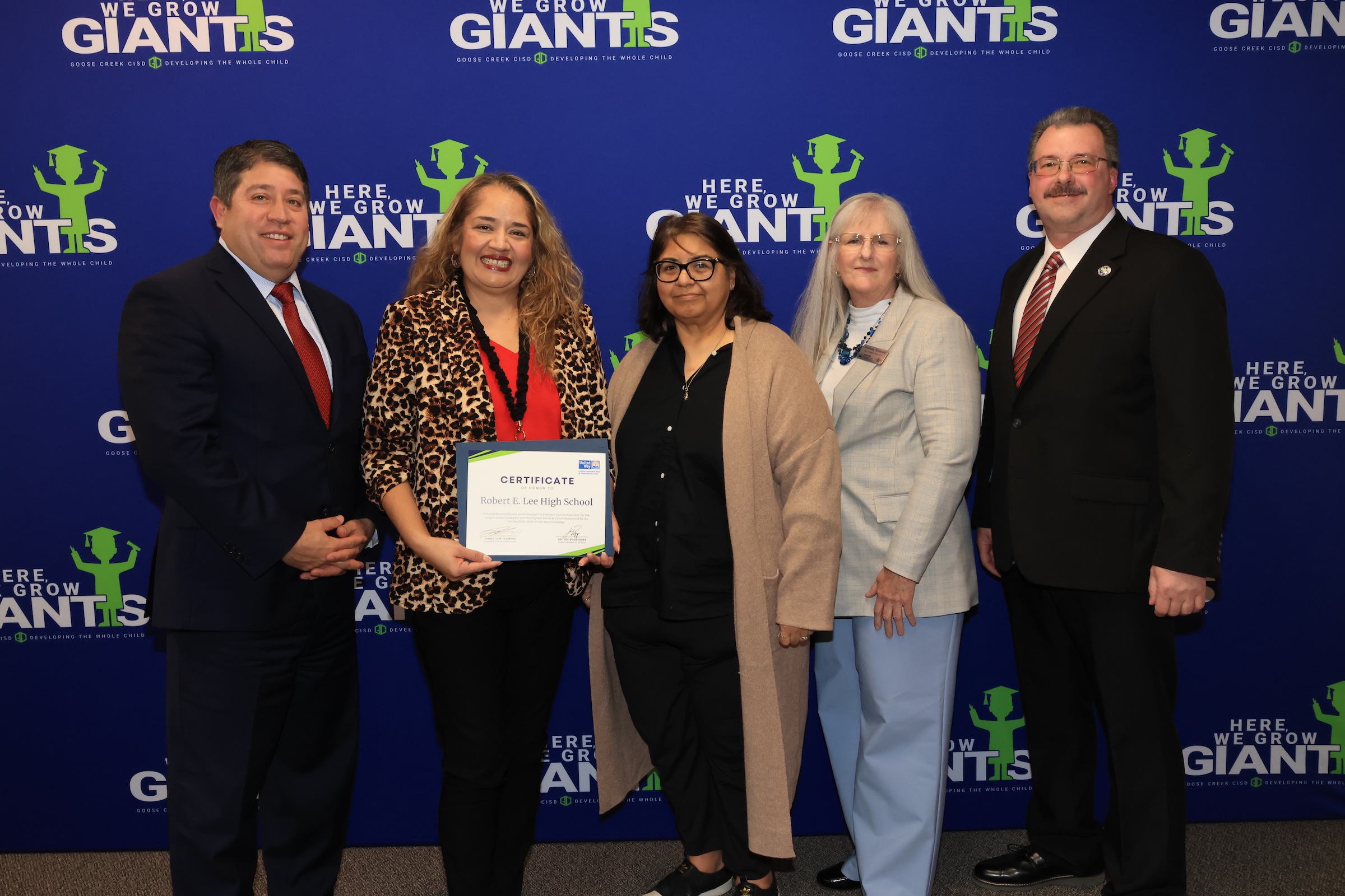 Lee High School representatives pose with recognition and board president and joe rodriguez