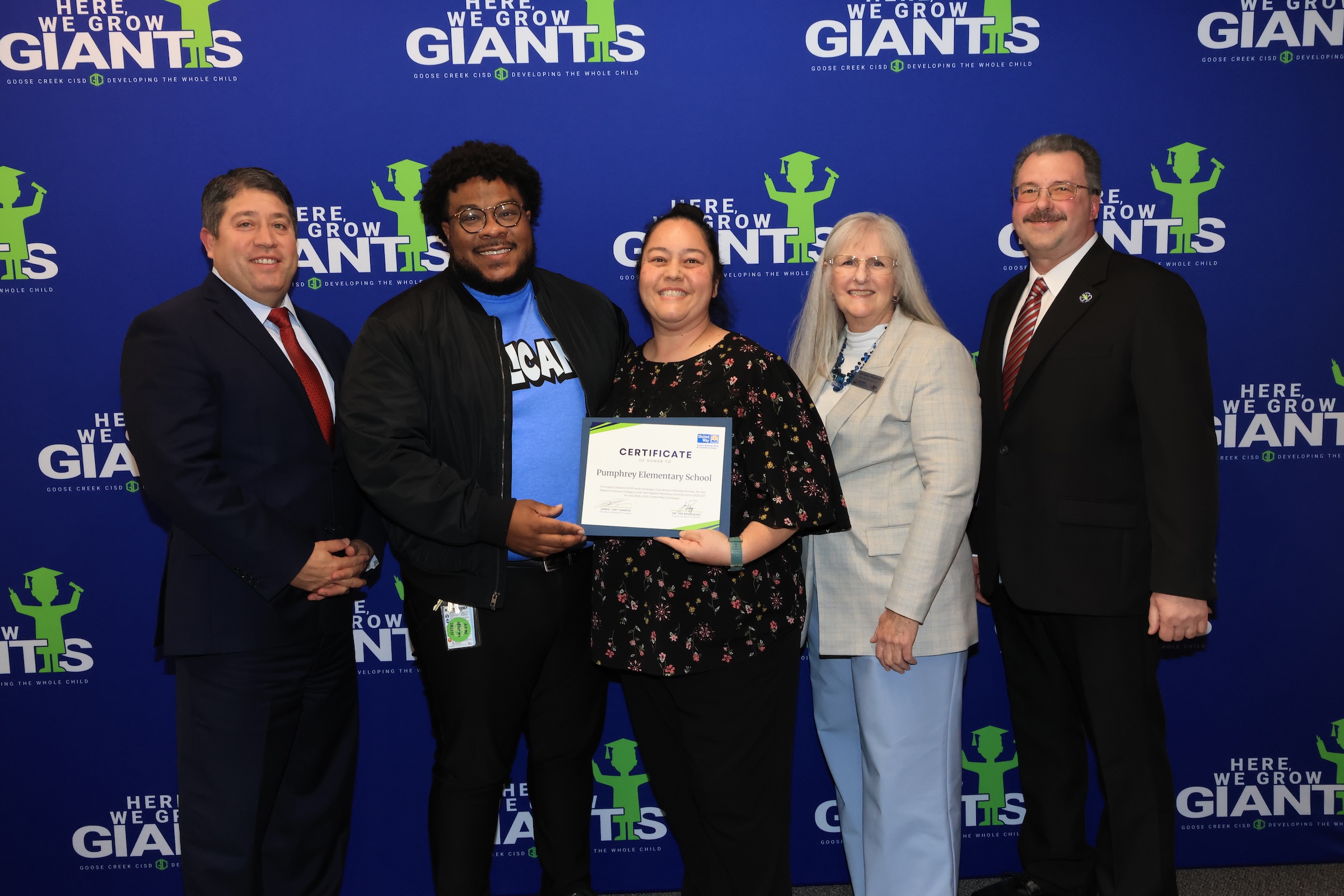 Pumphrey Elementary representatives pose with recognition and board president and joe rodriguez