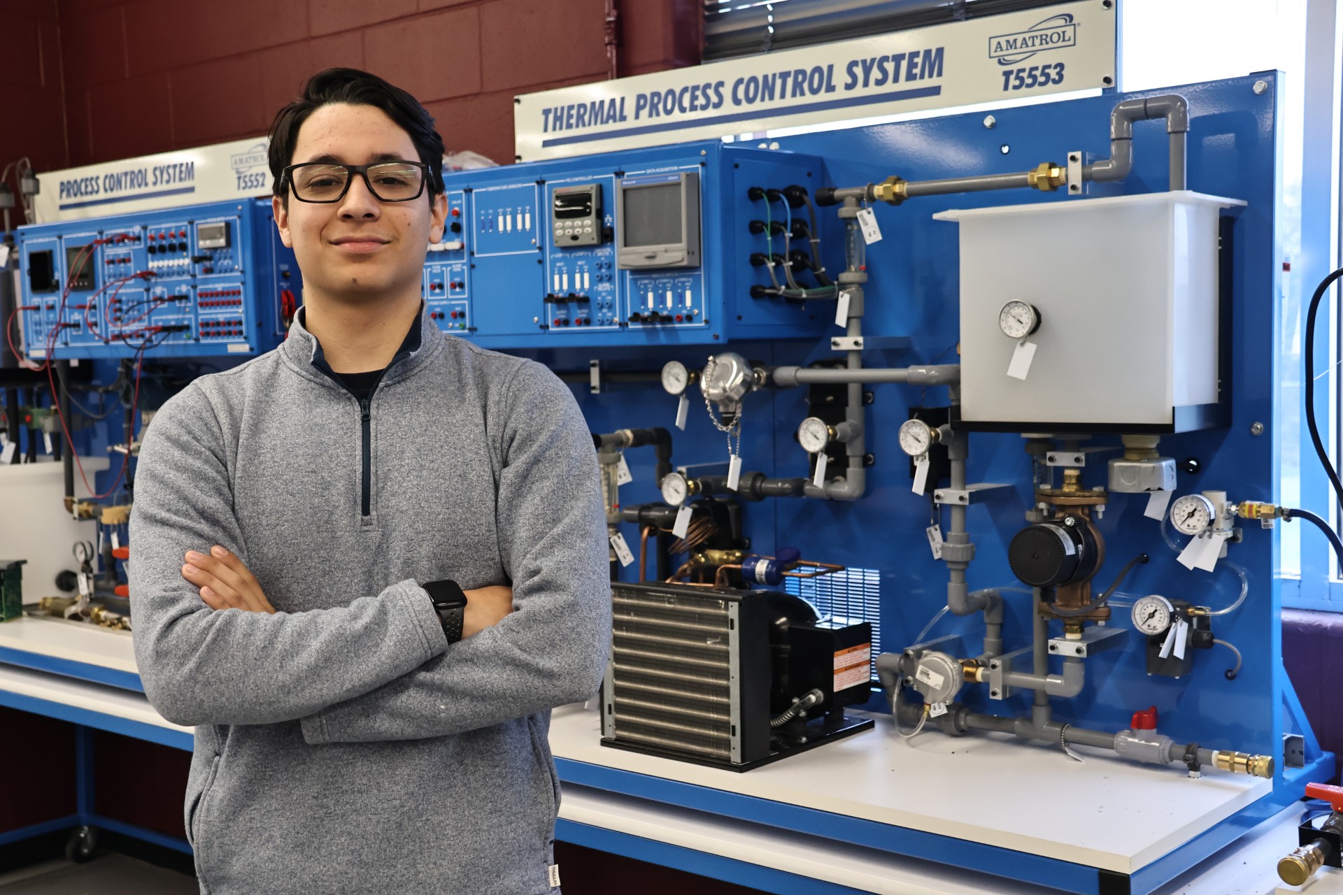 Samuel Munguia standing in front of instrumentation equipment